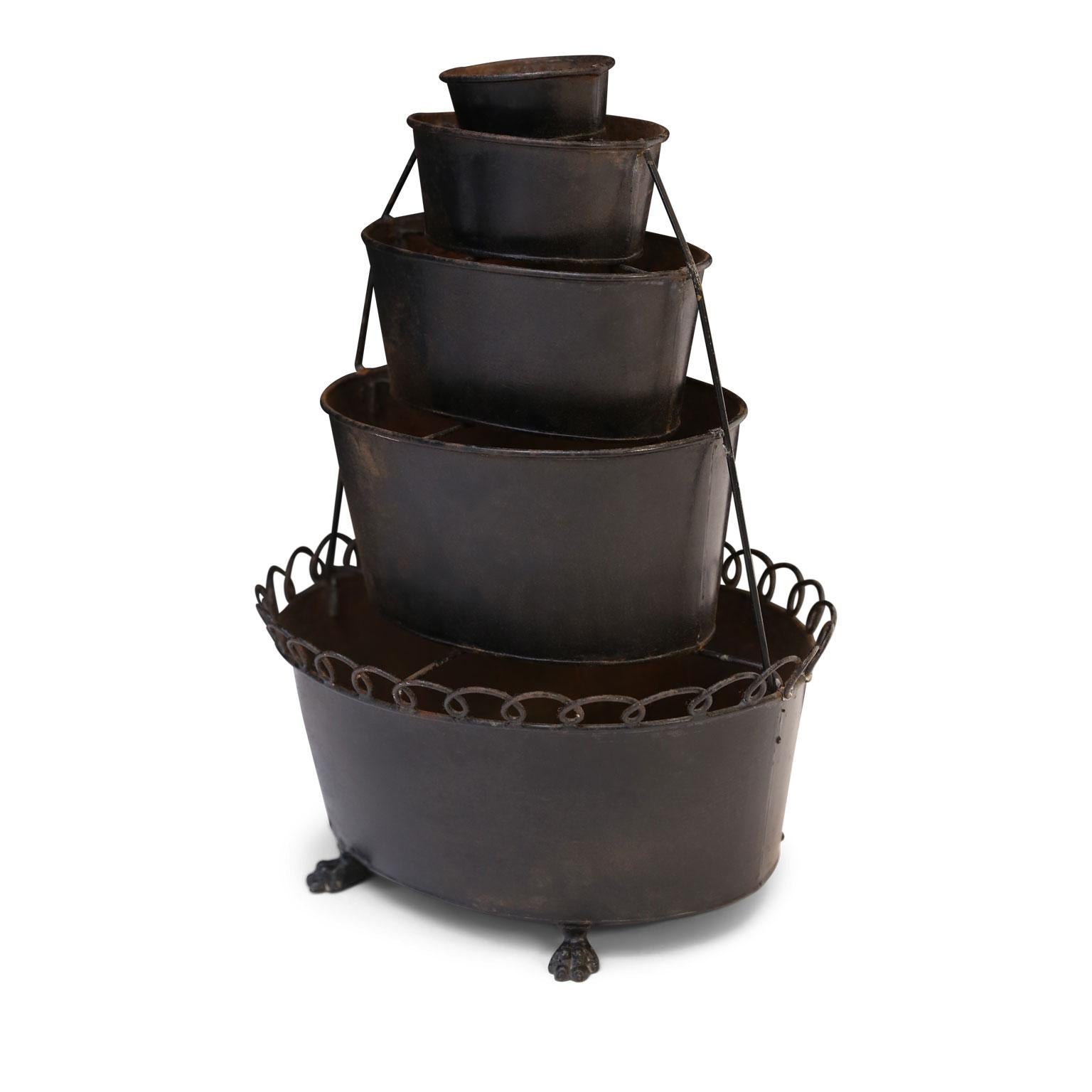Vintage black painted tole tulipiere-shape five-tier jardinière raised upon cast lion paws. Lowest tier of this plant stand is bordered by a decorative wire gallery-edge.