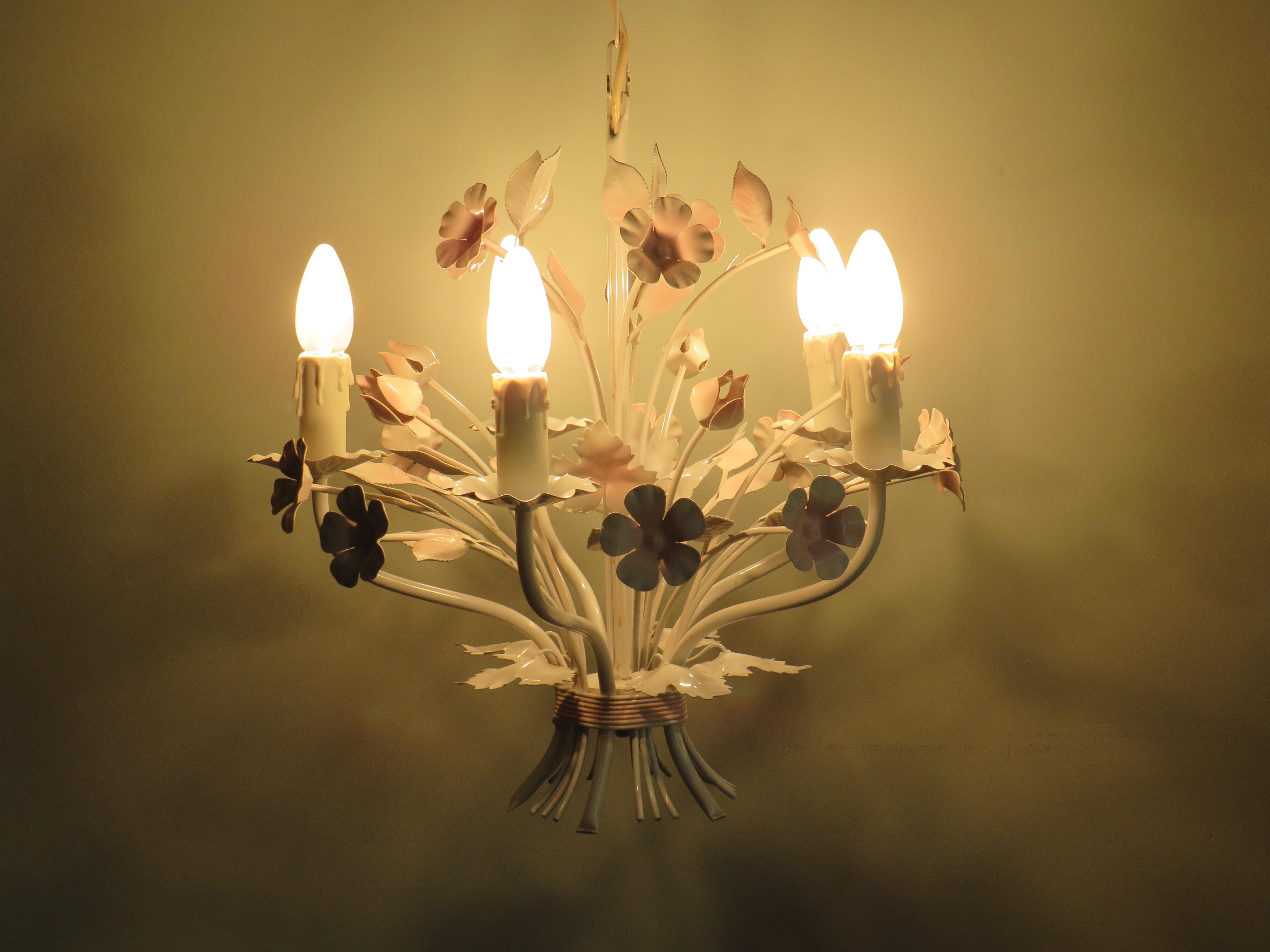 Vintage Toleware chandelier with floral motifs, Italy 1960s.
The chandelier has 5 light points (E 14) in the shape of dripping candles, furthermore the chandelier is equipped with many leaves, flowers and flower buds that meet at the bottom and