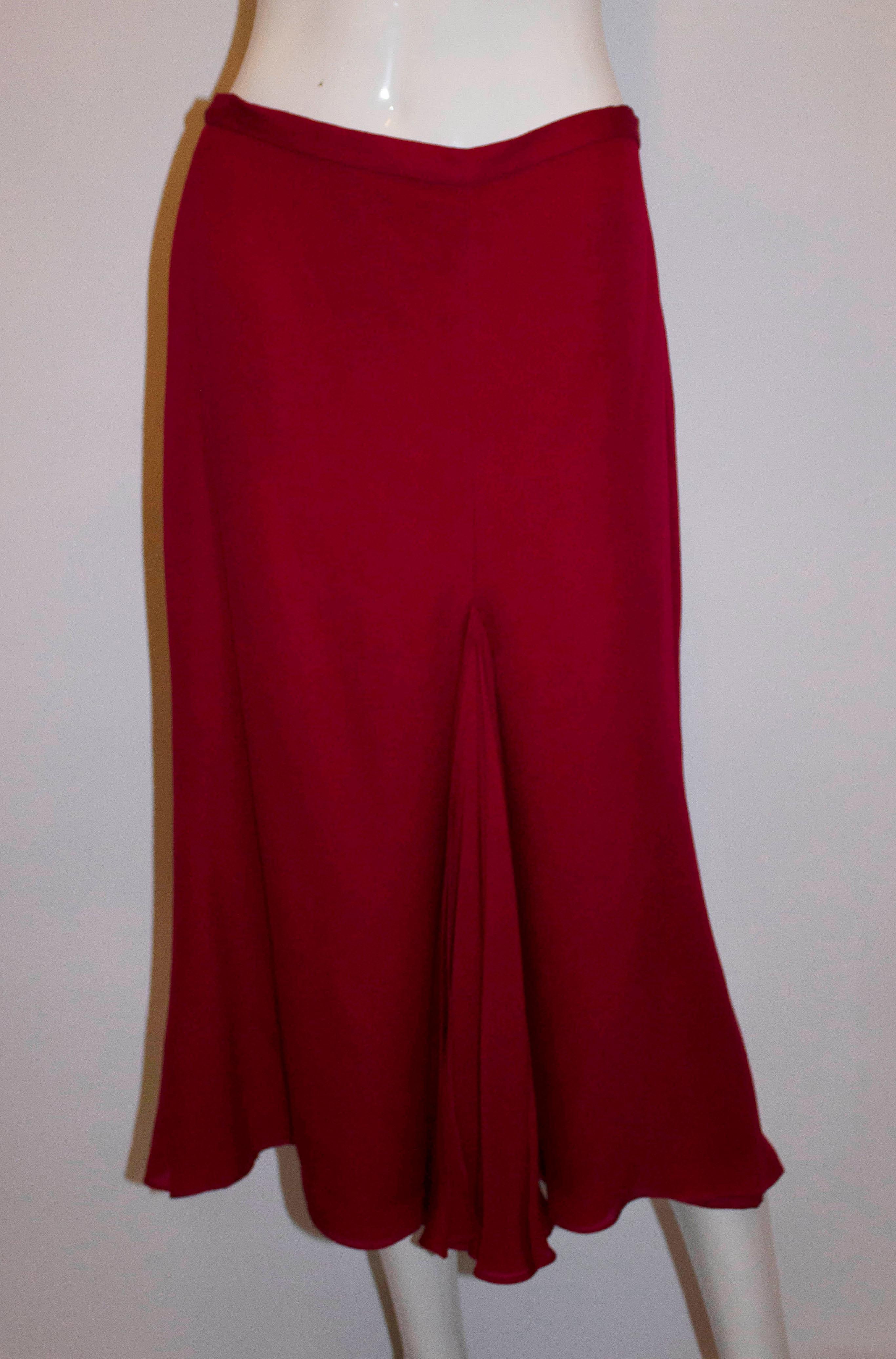 Un giro de cabeza  Traje vintage de Tomasz Starzewski Couture.  En seda roja carmesí , el top es de seda doblada y se puede llevar con o sin hombros. Está totalmente forrado, deshuesado y tiene una cremallera central trasera. La falda se compone de 