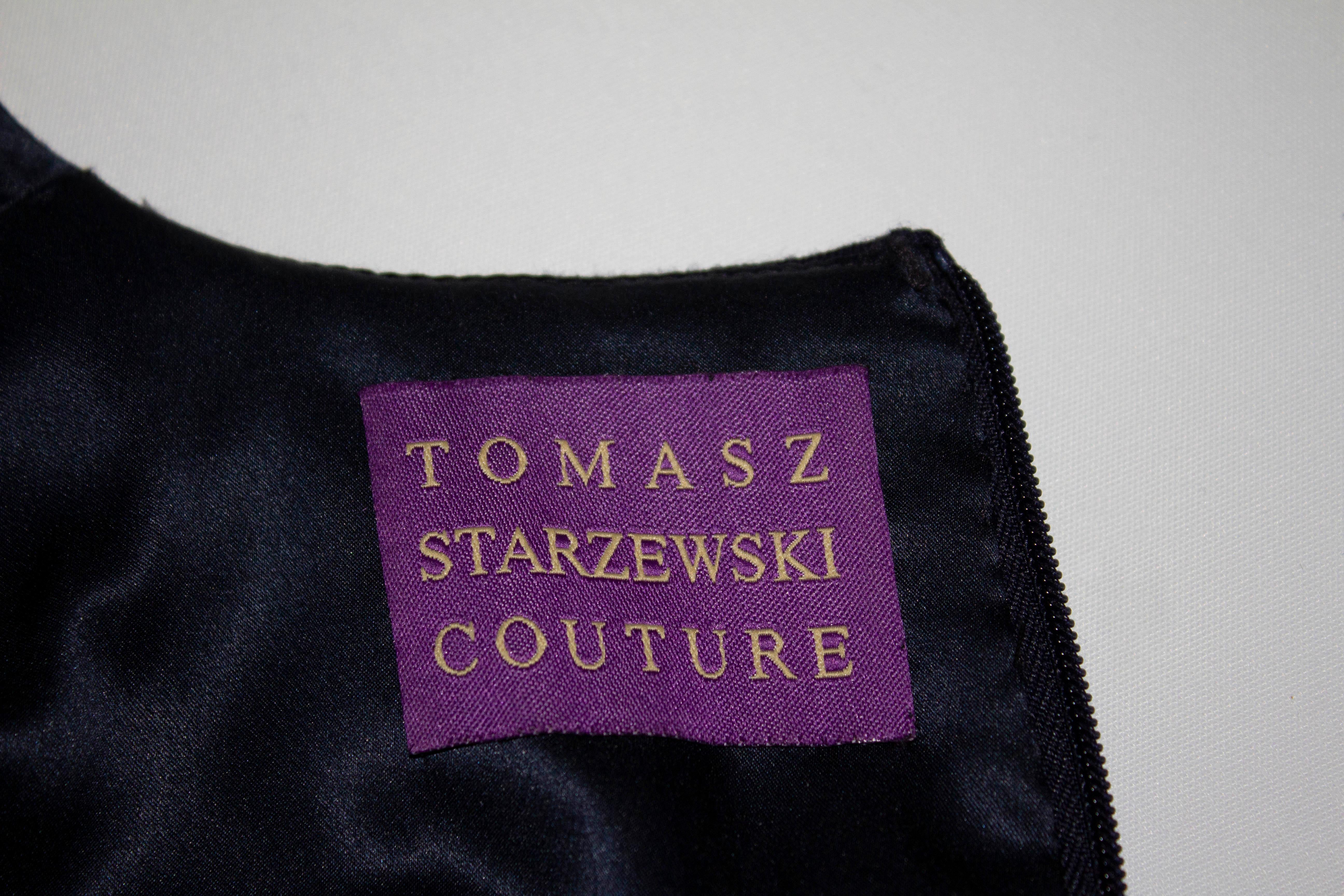 A chic vintage dress by Tomasz Starzewski Couture.  In a deep blue the dress has a knot detail on the front, short sleaves, central back zip and is lined in silk.

Measurements: Bust 36'', length 44''
