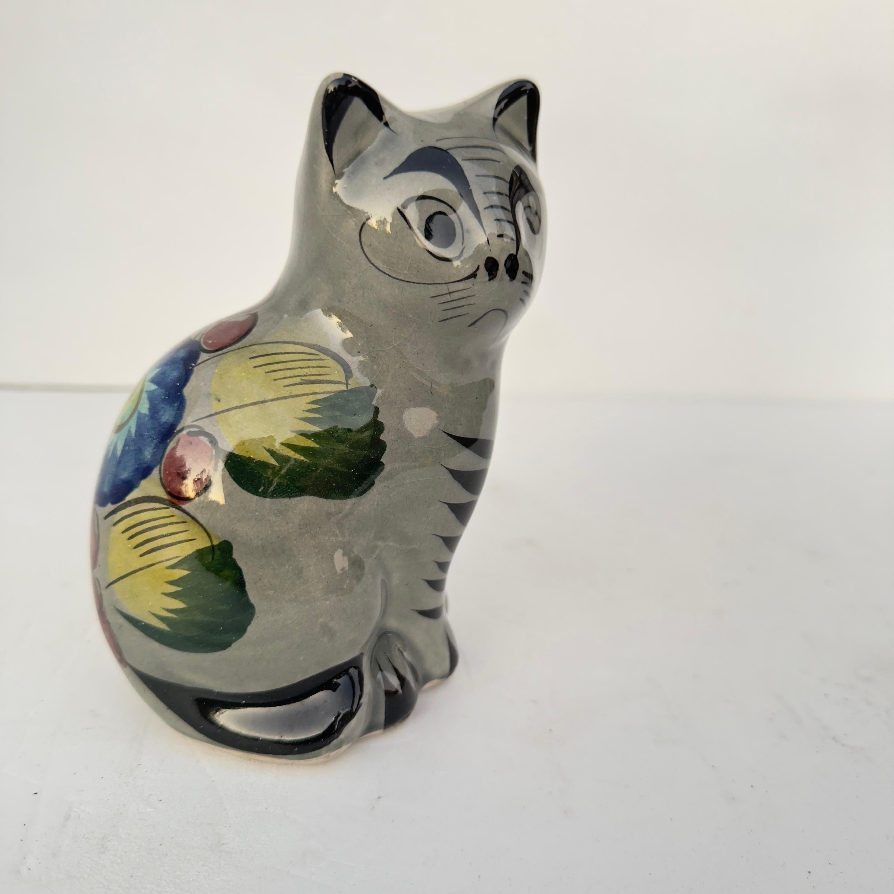  Vintage Tonala figurine of a cat. Glazed with a floral design. No chips or cracks. In great condition. Measures 6 inches tall by 4 inches wide by 3.25 deep. 