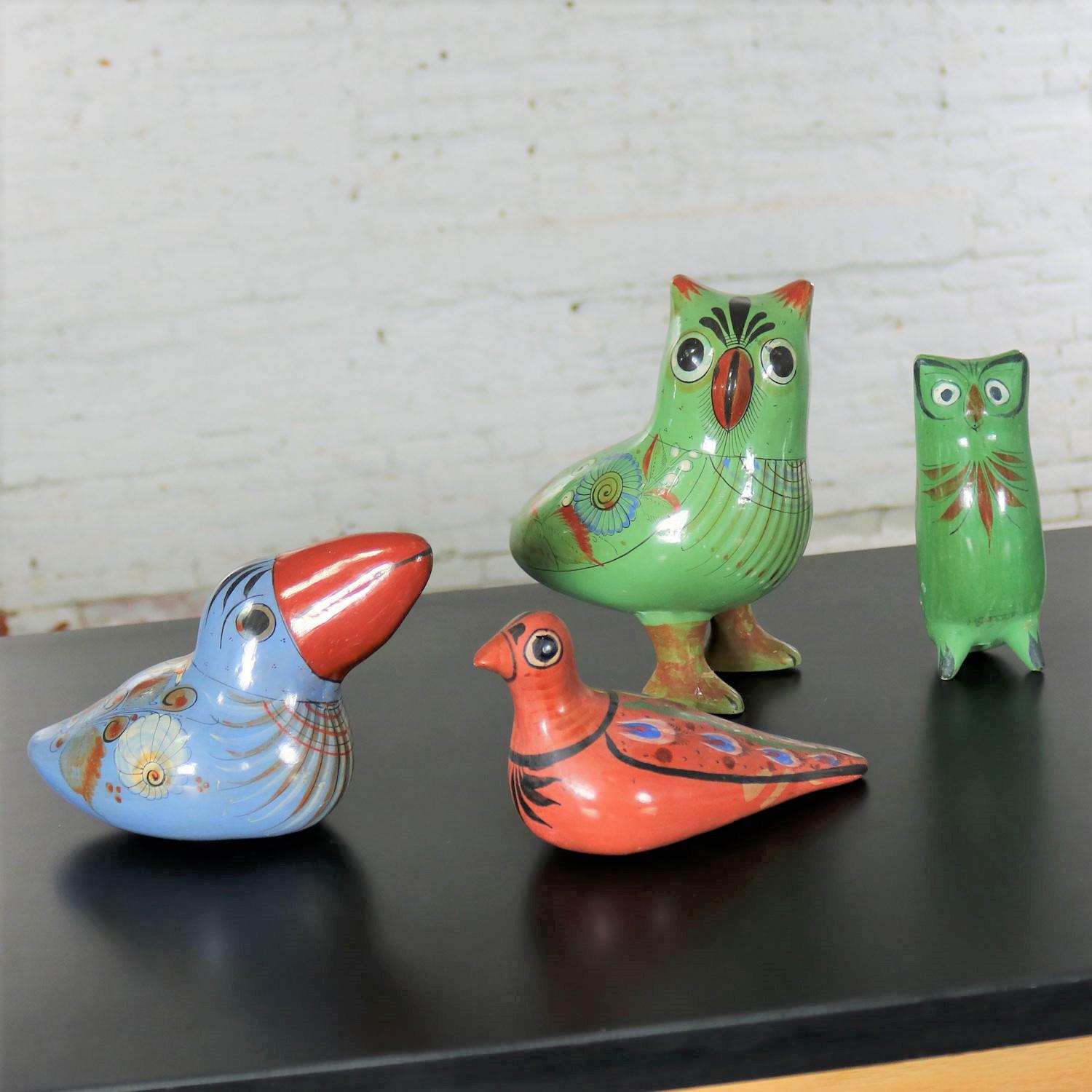 Instant collection of four hand painted midcentury vintage Tonala pottery birds. Two green owls, one blue toucan, and one russet dove. They are all marked in some way, and all are in wonderful vintage condition. The large owl when tapped sounds like