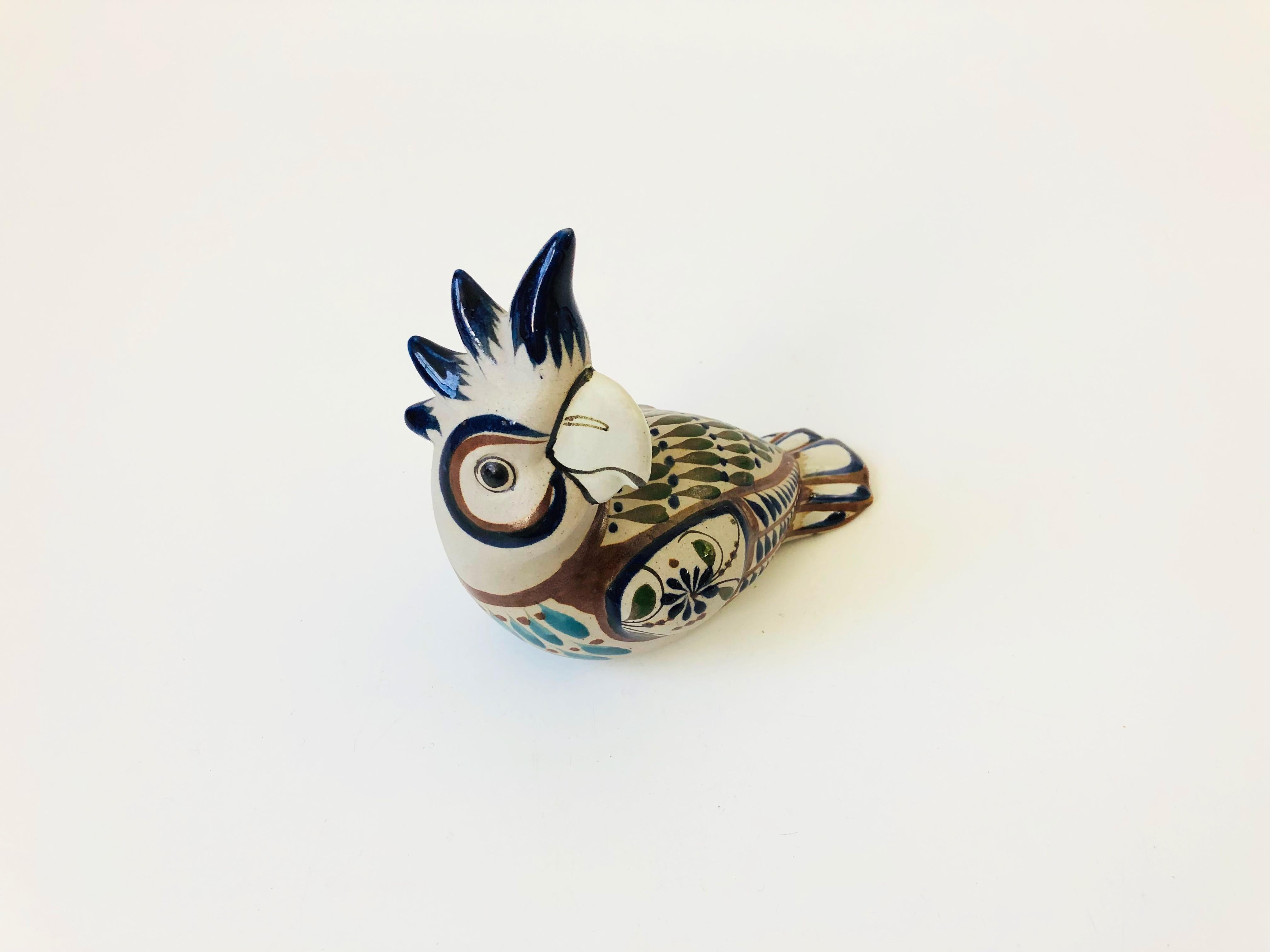 A vintage tonala pottery cockatoo. Made in Mexico, with beautiful hand painted designs in earthy colors.
 