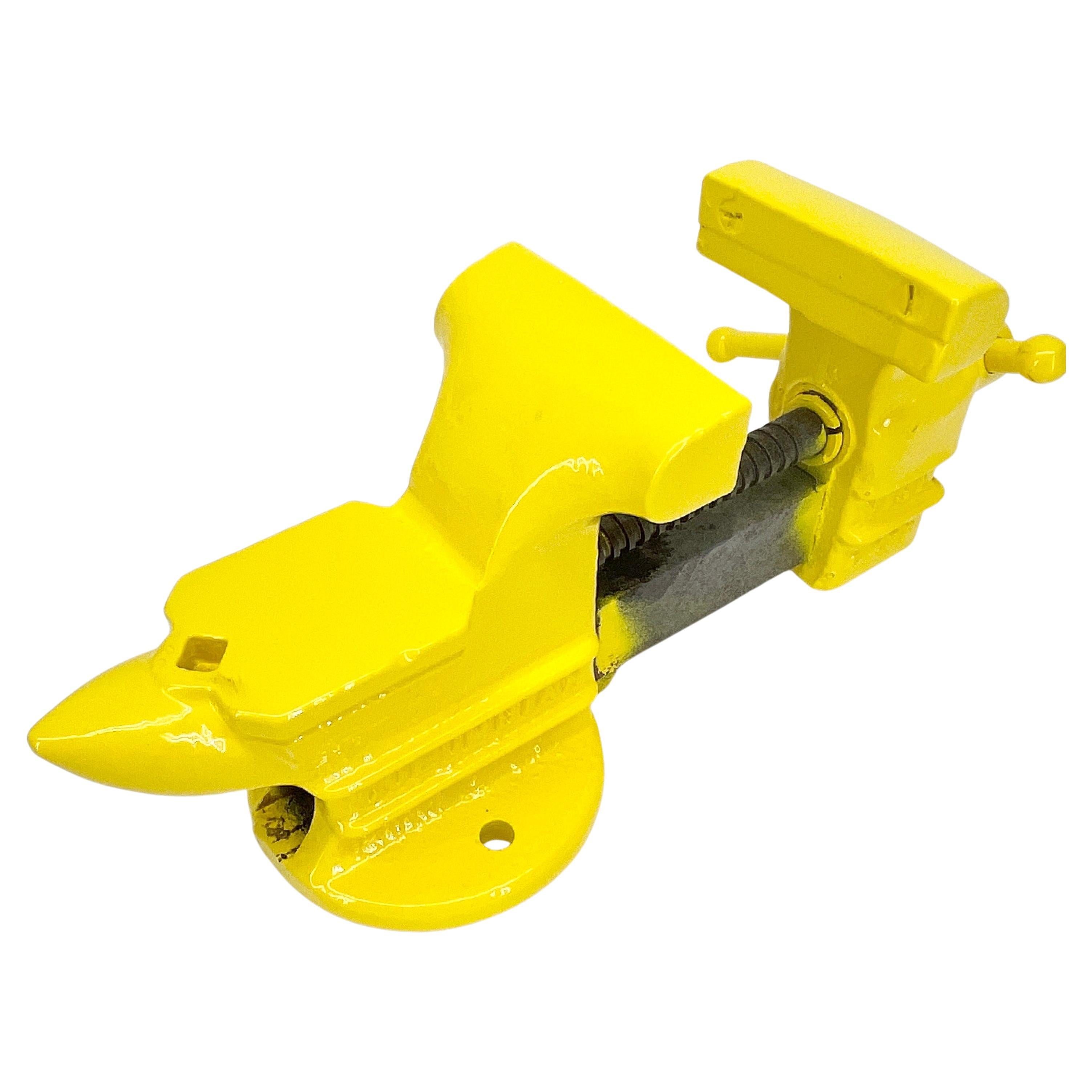 Vintage vice powder-coated in bright yellow. 
Just look at this antique vice which has been painted in 