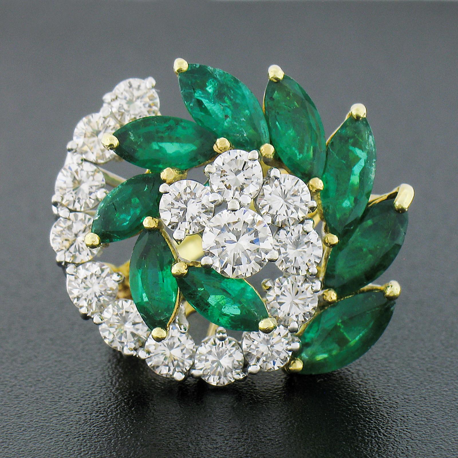 Here we have an absolutely outstanding, vintage, diamond and emerald swirl ring that was crafted from solid 18k yellow and white gold. This ring features a graduated dual-pronged swirl pattern with one prong constructed from round brilliant cut
