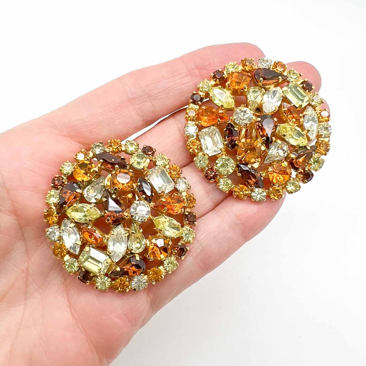 Stunning Vintage Fancy Cut Topaz Earrings. A wonderfully generous sized disc is set individually with a myriad of fancy cut crystals emulating precious stones including topaz and citrine. Add for a pure statement of glamour and timeless