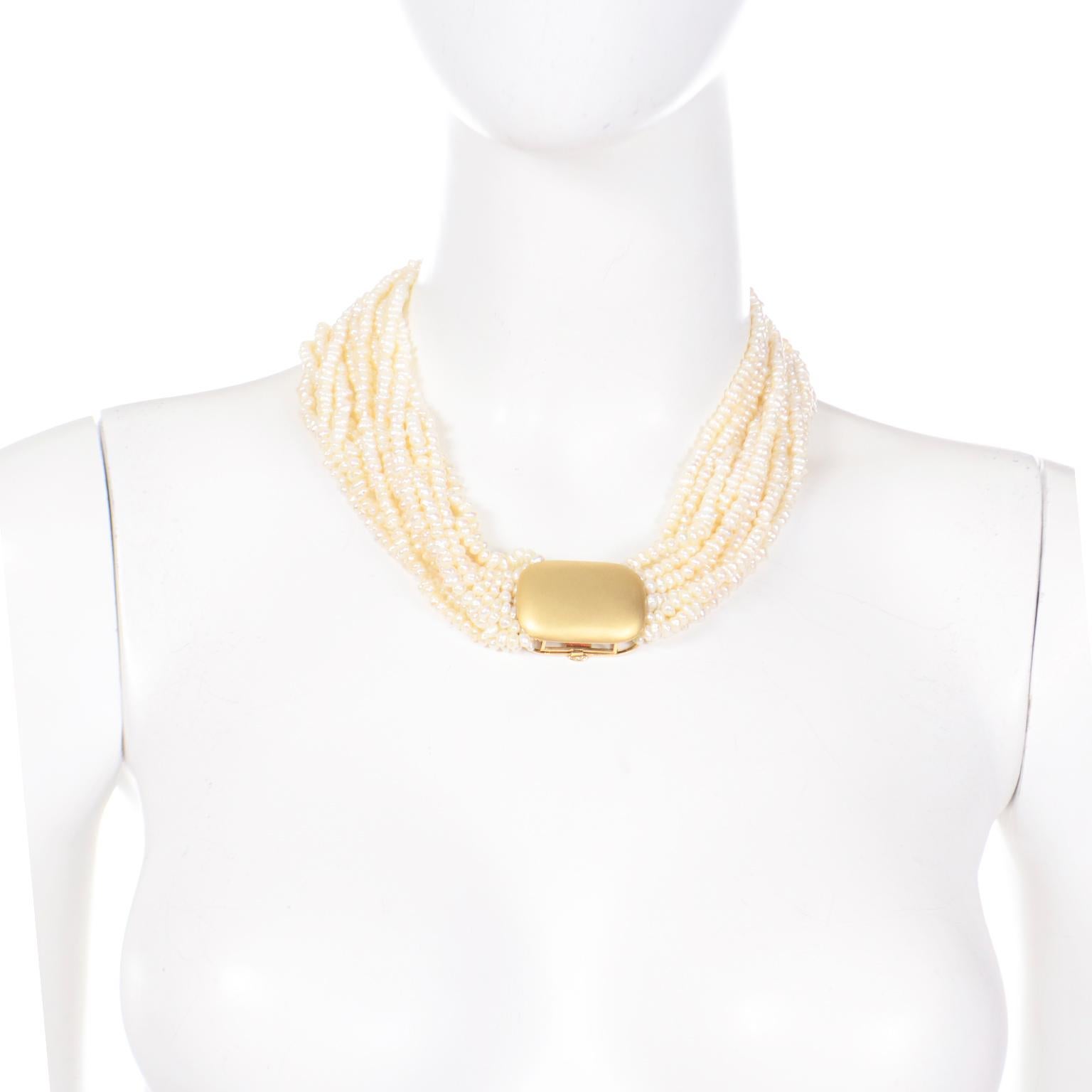 This is a truly gorgeous vintage multi 12 strand pearl necklace with a beautiful 18k matte gold unique fold over clasp. This torsade style necklace can be worn with the clasp showing or with only the beautiful pearls showing. This is an incredible