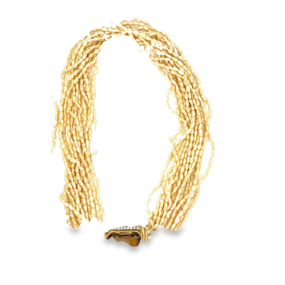 The necklace has 15 strands of small, freshwater pearls. This torsade-style necklace can be worn with the clasp showing or with only the beautiful pearls showing. The strands can be worn loose or twisted together for a whole different look.