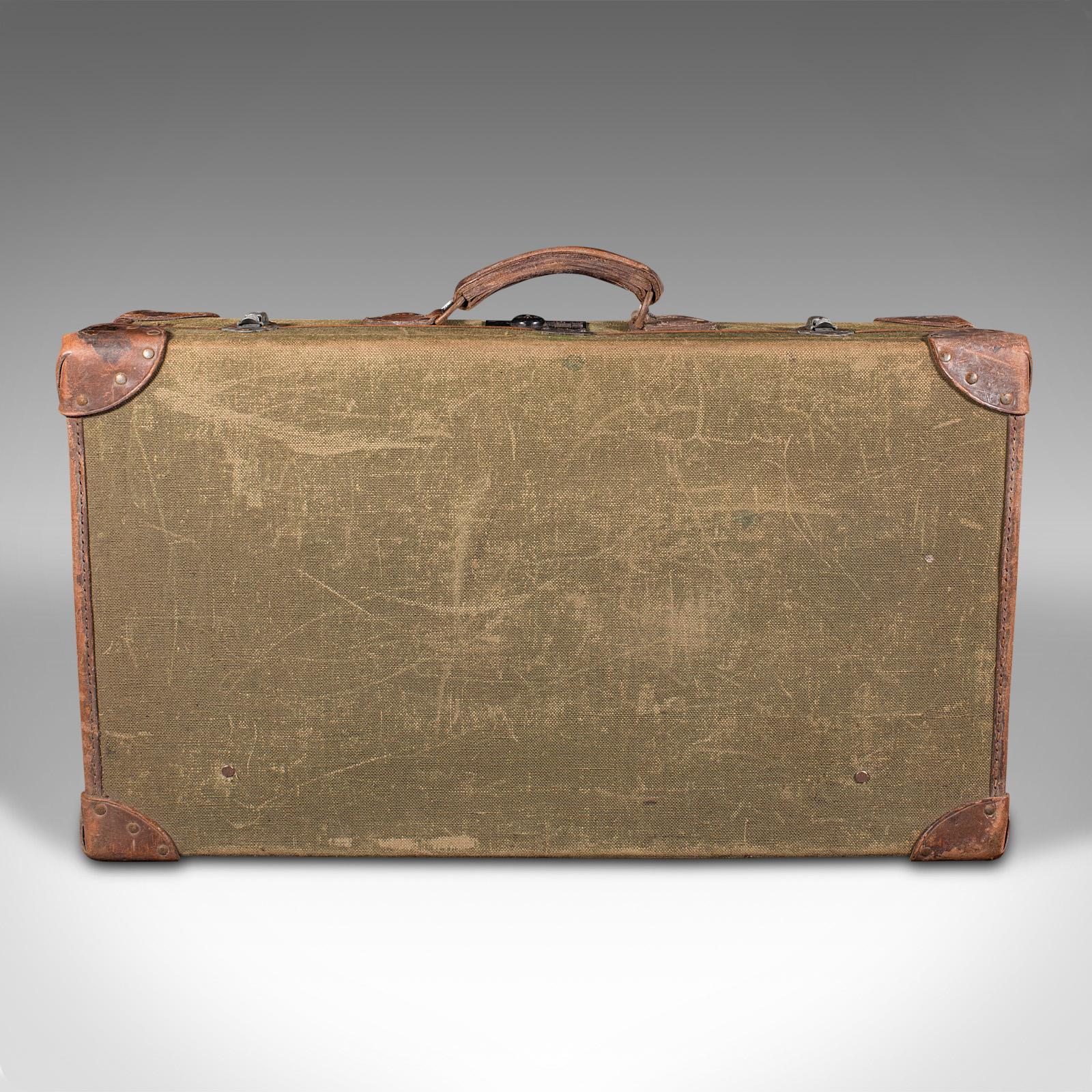 This is a vintage touring picnic set. An English, canvas and leather case, dating to the mid 20th century and later, circa 1950.

Charming vintage set, ideal for the luggage rack of classic sports cars
Displays a desirable aged patina