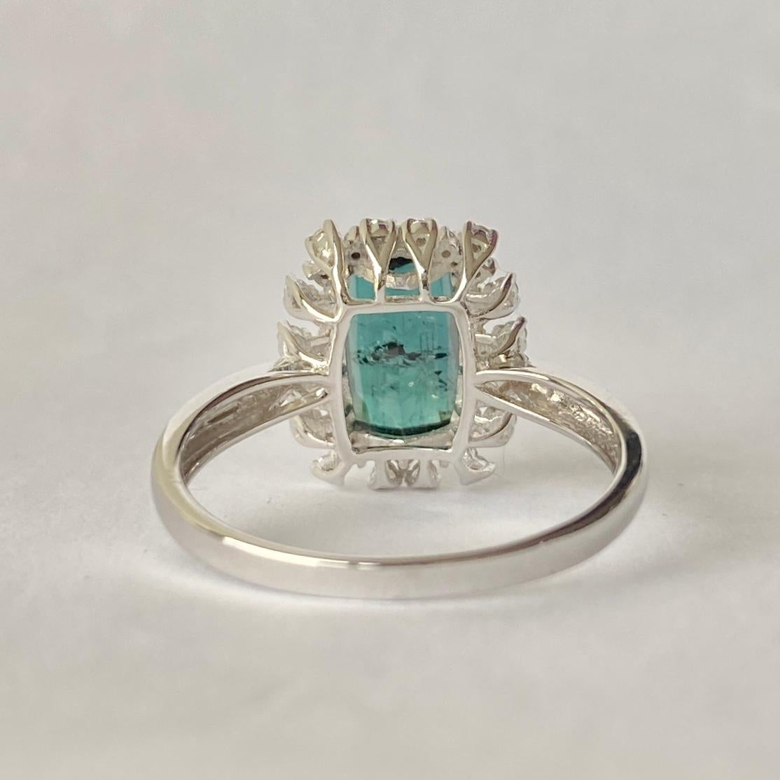 This gorgeous tourmaline is a deep inky blue/green colour and measures approx 2.5carat. This stone is surrounded by diamonds totalling 30pts. Modelled in 14carat white gold. 

Size: N 1/2 or 7 
Cluster Diameter: 13x11.5mm

Weight: 2.9g