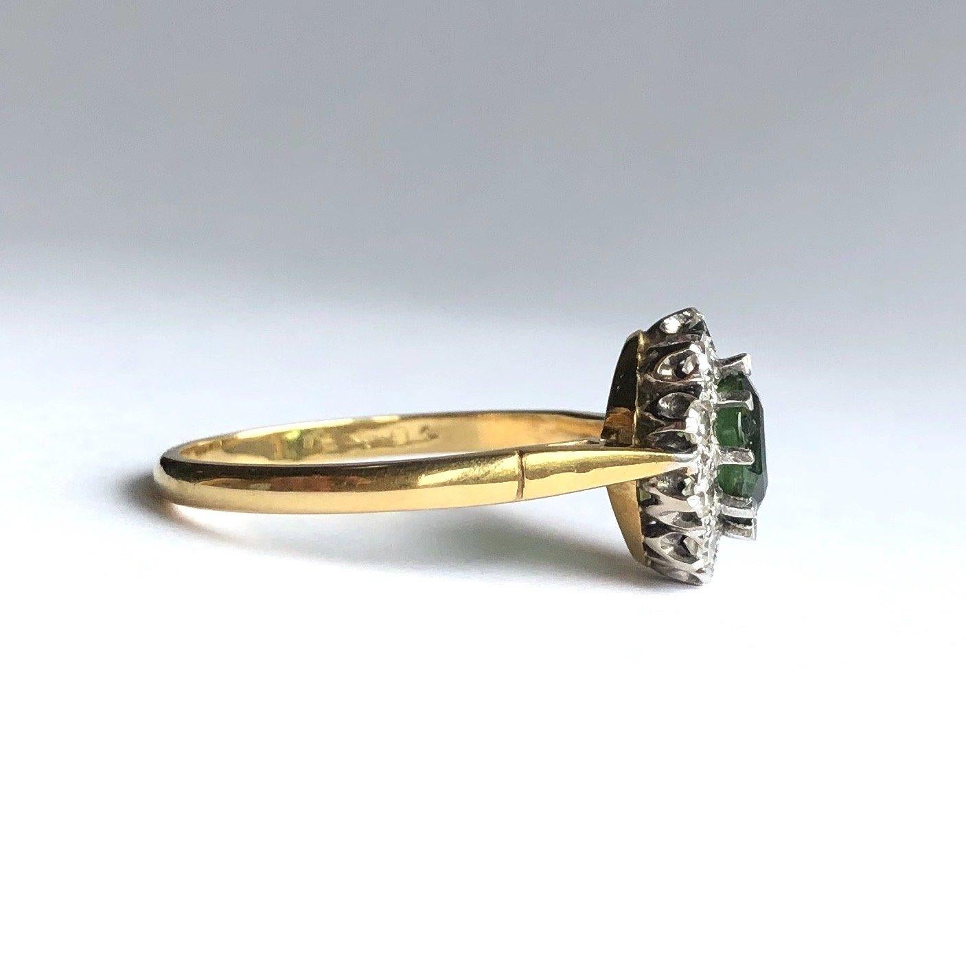 The tourmaline in this ring is such a beautiful colour and thee cut makes the stone look like it is never ending, almost like a hall of mirrors! The tourmaline measures 75pts and the diamonds total approx 50pts. 

Ring Size: Q 1/2 or 8 1/4 
Cluster