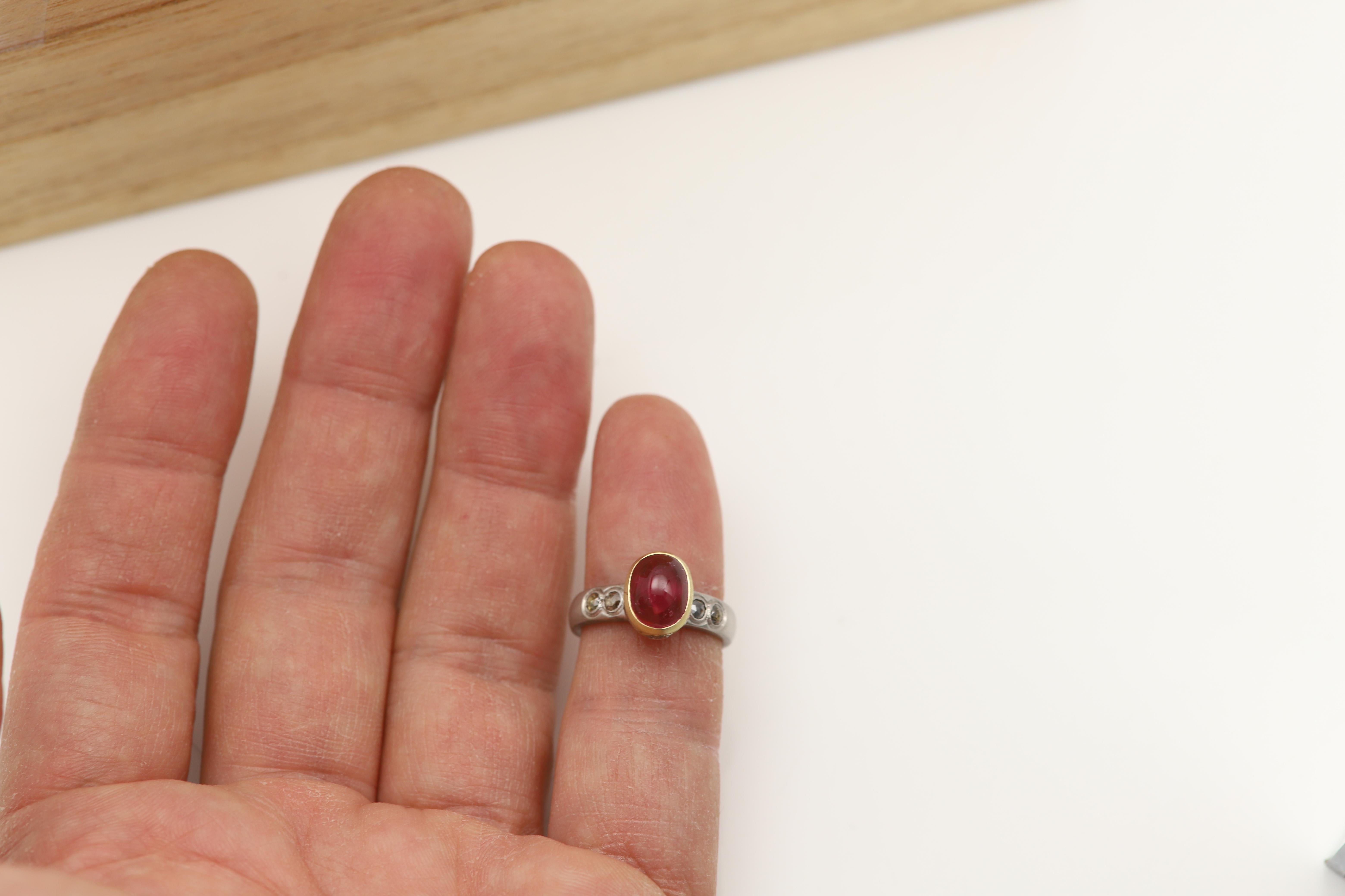 Natural Tourmaline 18k Gold Ring
Vintage -never used however has a aged look (was made  before year 2000 in Italy)
Natural Tourmaline Cabochon cut
has a strong pink luster at certain angles and or at certain light.
stone size: Approx 9x7mm / 3.0