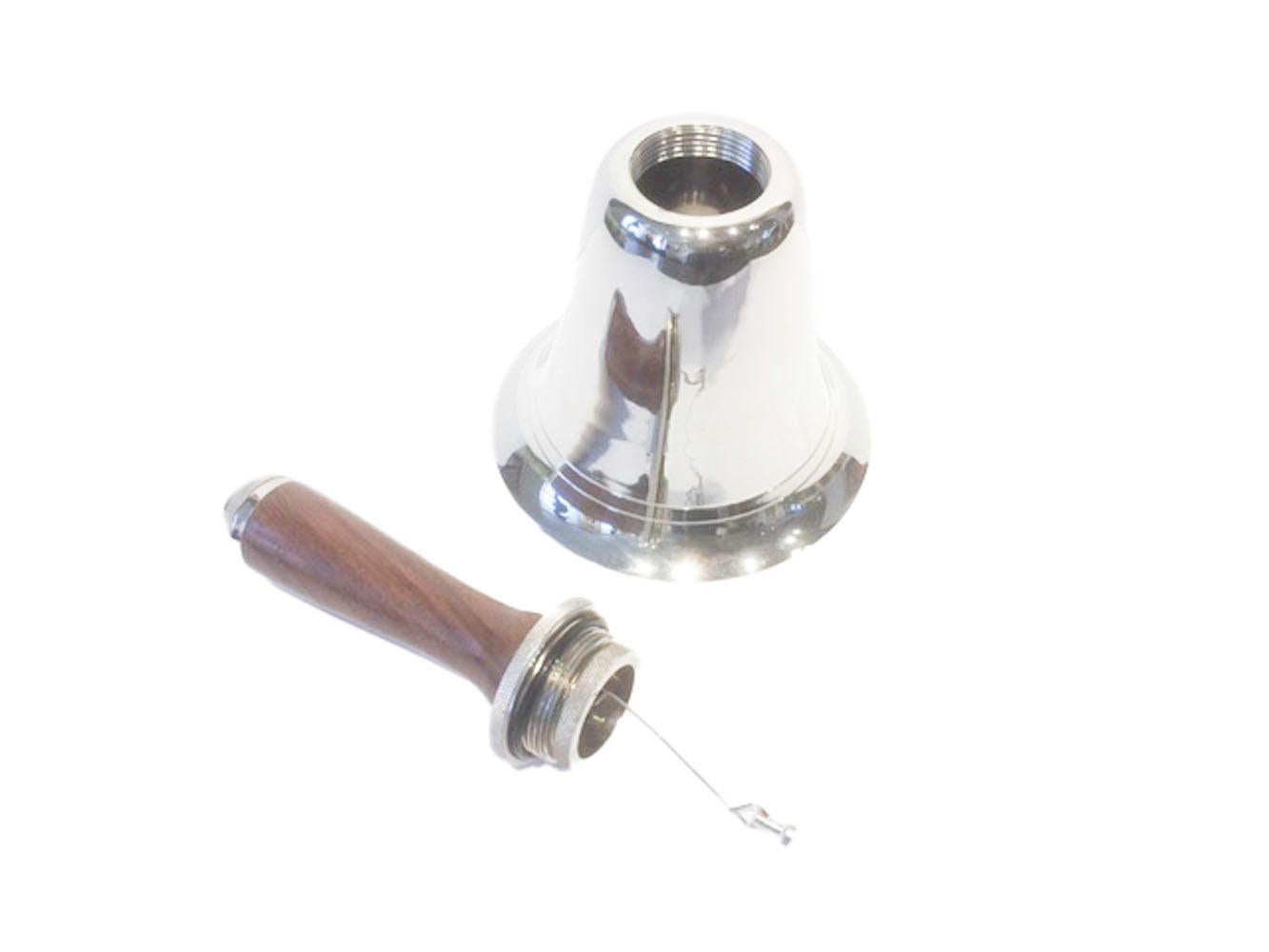 Vintage chrome and wood cocktail shaker in the form of a bell. The handle unscrews from the top of the bell allowing you to fill the shaker. The handle has a strainer built in to the screw fitting from which the clapper hangs. Once you've replaced