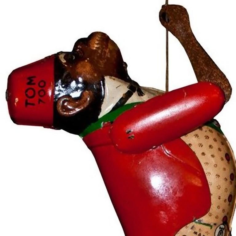 This mechanical monkey is an original vintage toy.

Vintage mechanical toy representing a climbing dressed monkey.

It was made in tin in Germany in 1930s.

Marked as 