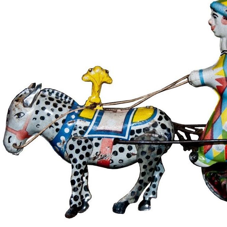 This wind up clown on cart and donkey is a vintage wind up toy representing a multicolor clown in a cart and a donkey. 

Made in tin, made in Ussr. Probably produced in the 1960s. 
The toy is marked with 