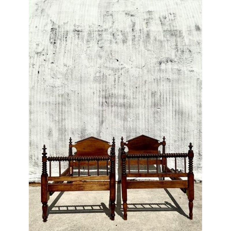 Step into a world of classic elegance with this exquisite pair of vintage barley twist twin bed frames, showcasing the finest craftsmanship of traditional woodworking. Each frame features beautifully turned barley twist posts - a signature detail of