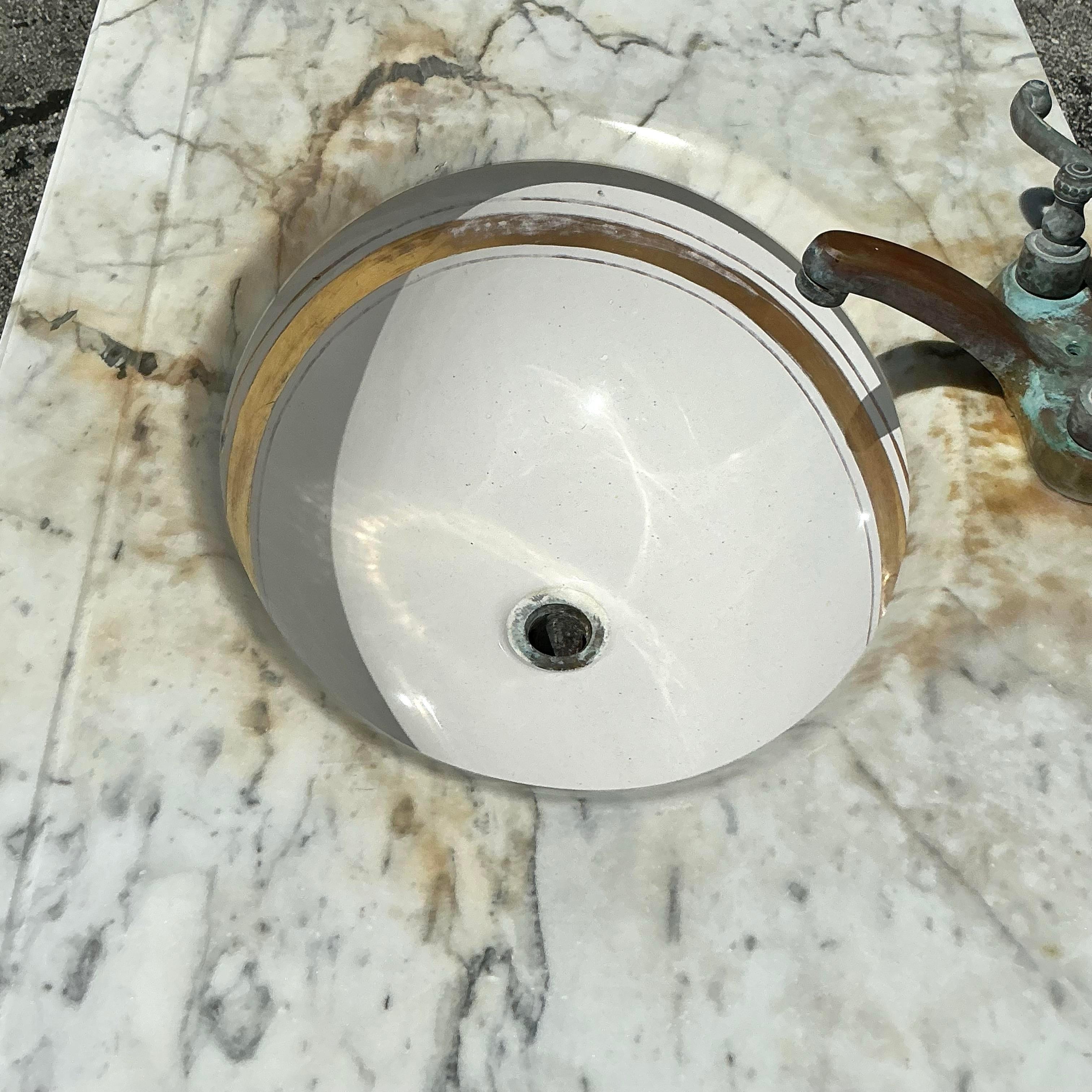 A stunning vintage Boho single sink vanity. Beautiful hand carved wood detail with a beautiful patina from time. A fabulous oxidized finish on the hardware. Acquired from an original Palm Beach estate designed by the iconic architect John Volk.