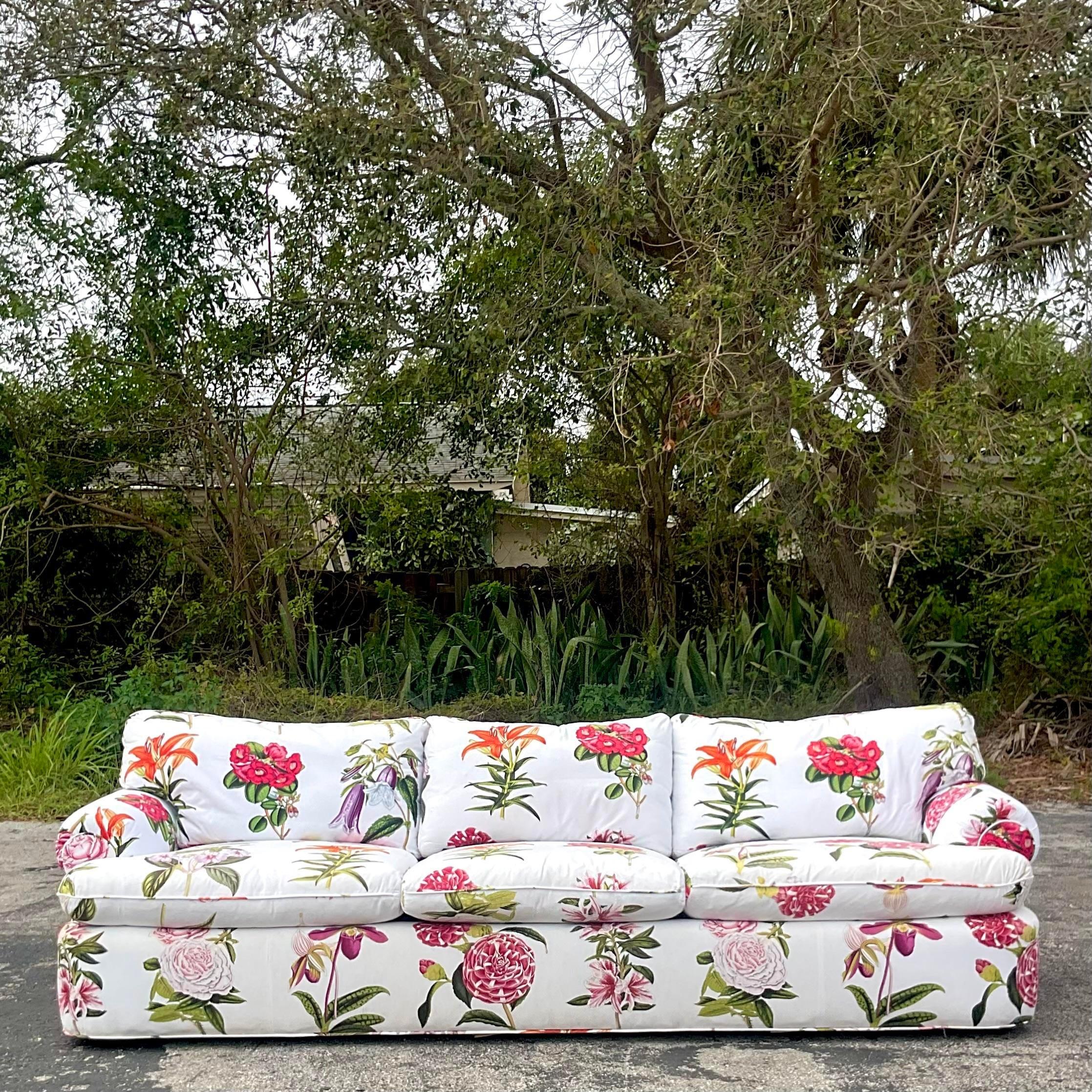 A stunning vintage Boho sofa. A brilliantly colored floral print on a pique weave cotton. Extra long for extra glamour. Coordinating pieces also available in the same print. 