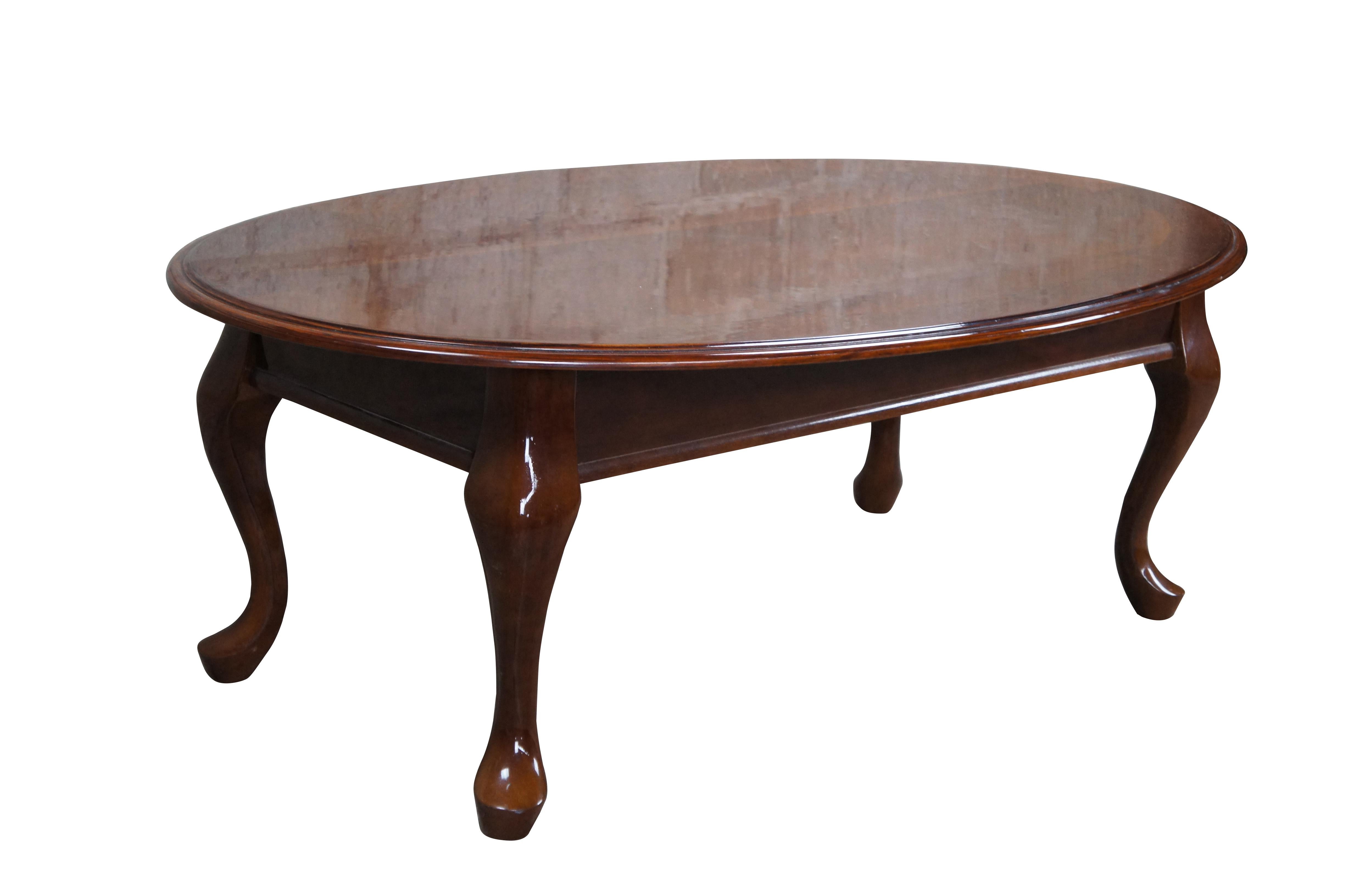 Vintage Queen Anne style coffee or cocktail table featuring oval form with serpentine legs and pad feet. 2 Available

Dimensions:
27