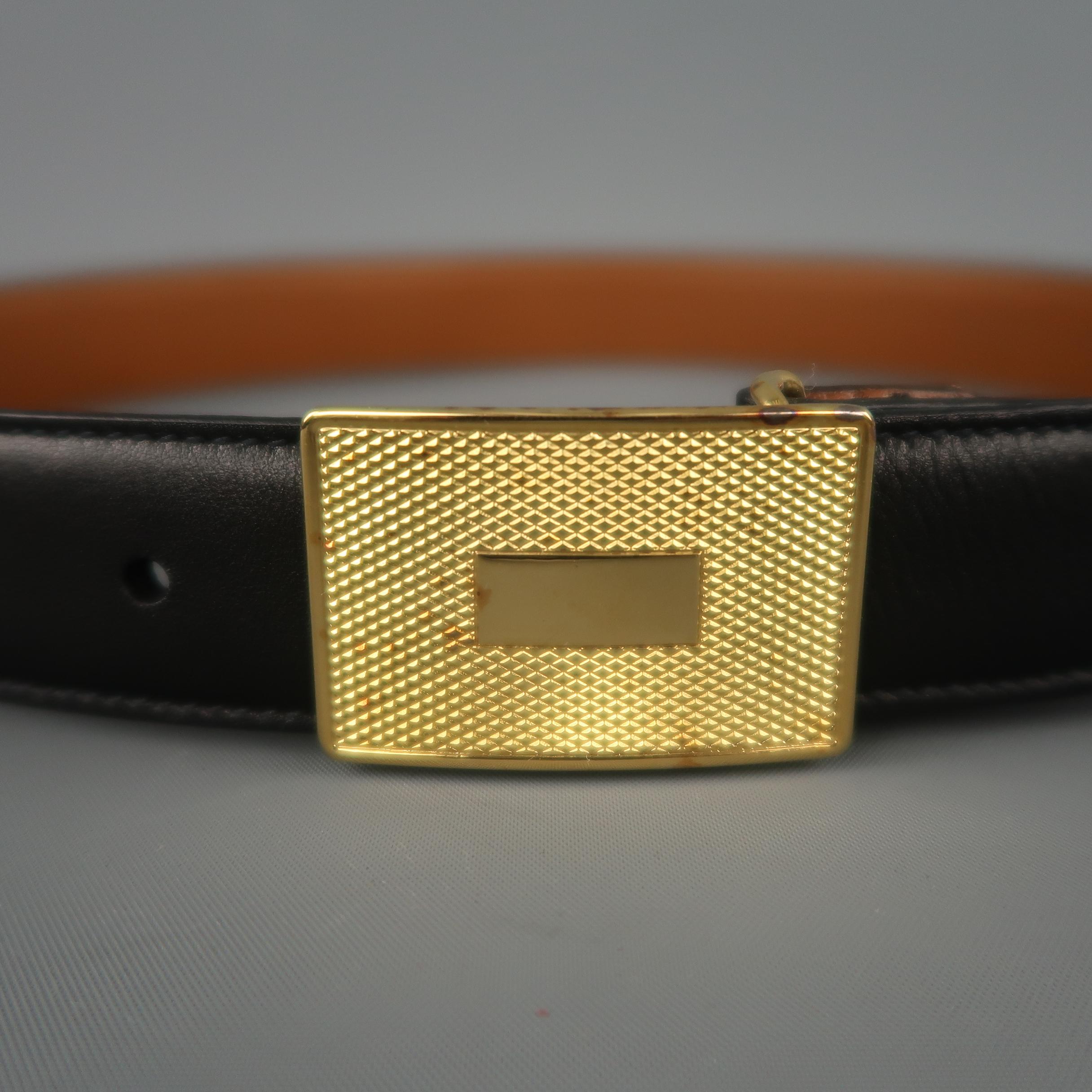 Vintage TRAFALGAR dress belt features a black strap with a yellow gold tone textured rectangular buckle. Aging on metal. As-is. Made in USA.
 
Very Good Pre-Owned Condition.
Marked: 30/75
 
Length: 34.5 in.
Width: 1.05 in.
Fits: 27.5-30.5 in.