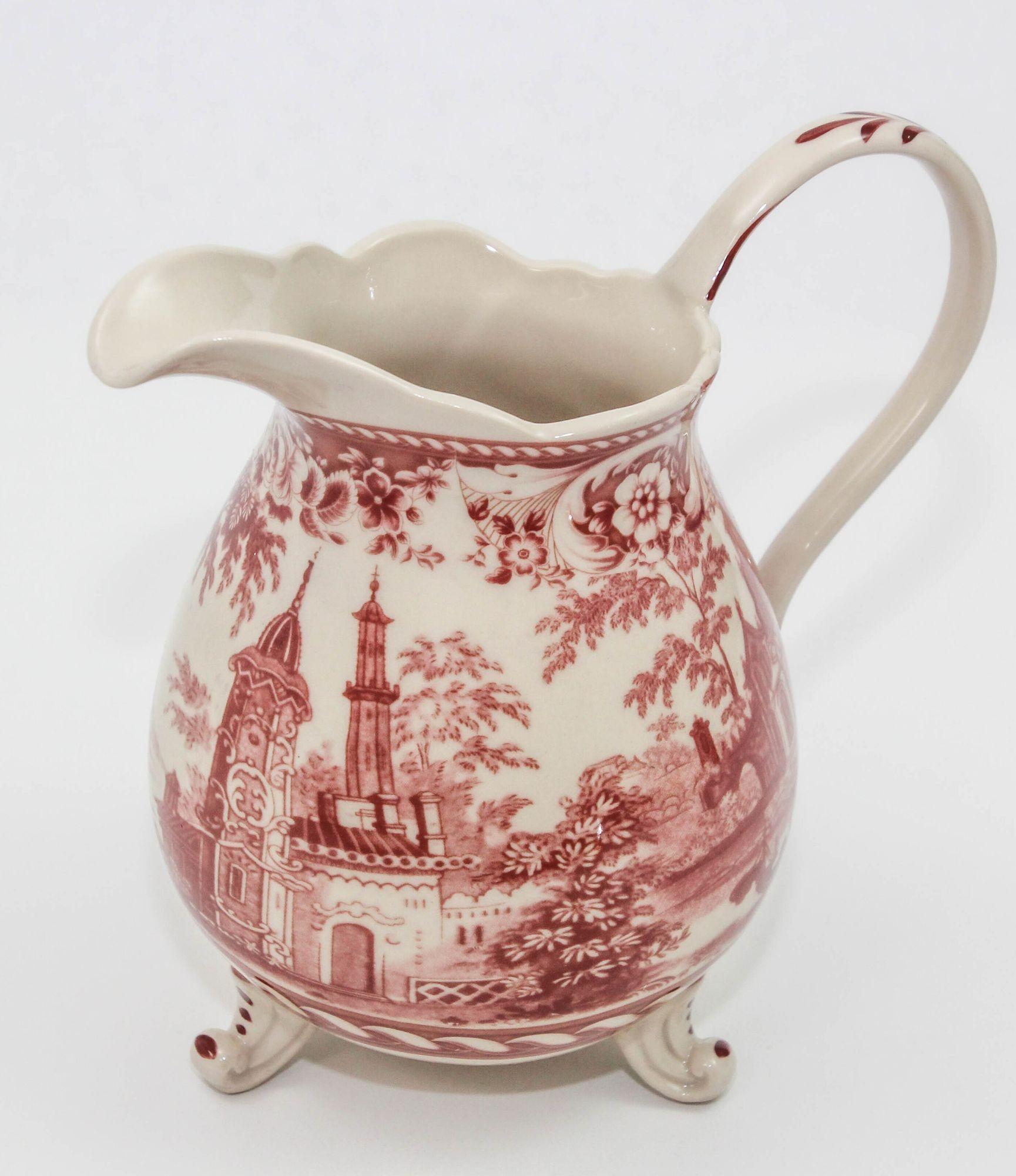 Vintage white and cranberry transferware porcelain footed pitcher
This is one of my favorite colors in ceramic Transferware, is the cranberry red Transferware.
This is a very nicely detailed pitcher with the pattern covering most of the surface and