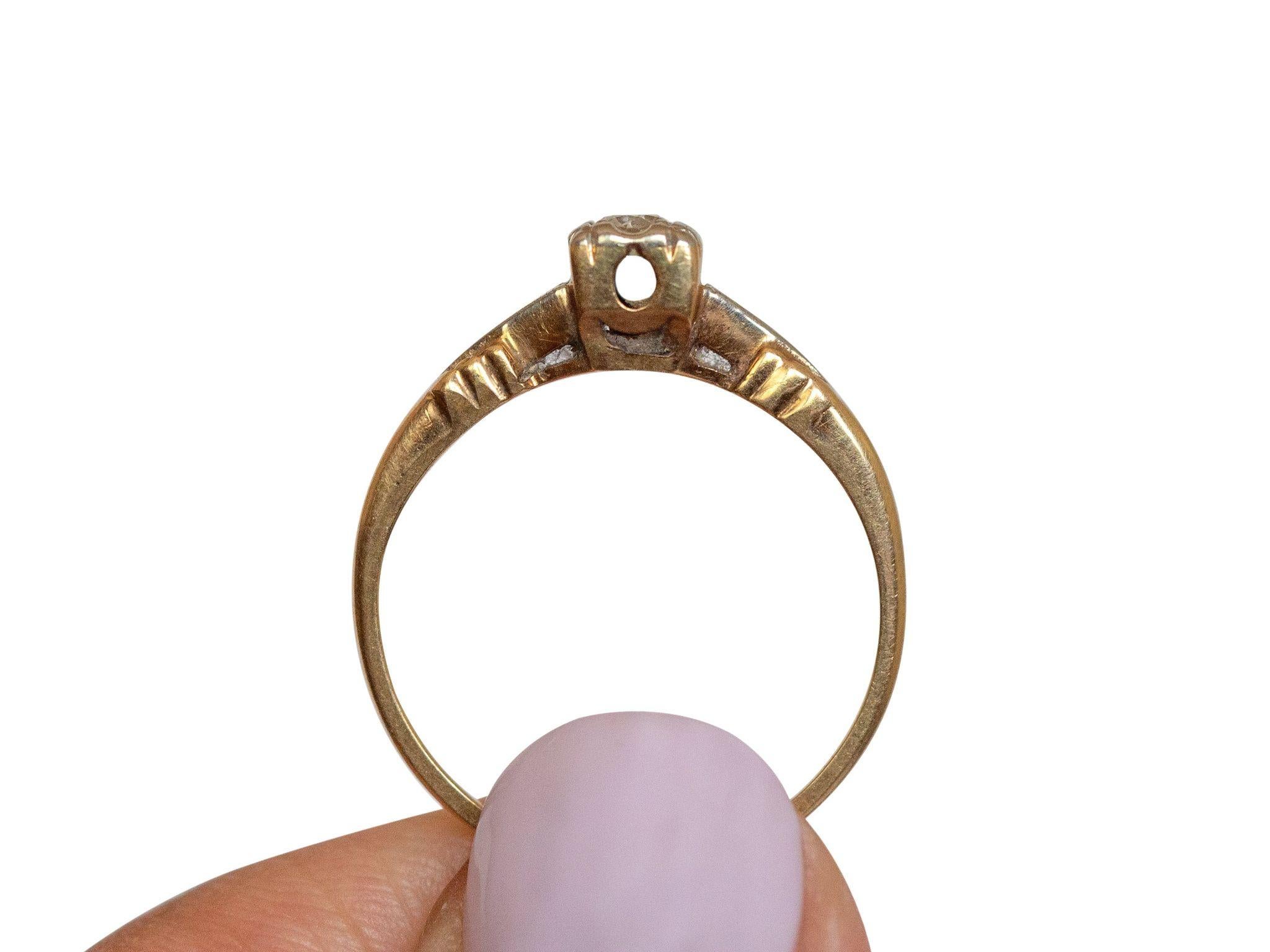 Here we have an beautiful example of a 1940's 14k yellow gold engagement ring that features a beautiful .10 ct diamond set beautifully in a simple yet elegant band. The detailed carving on the shoulder of the ring adds an eye catching effect. This