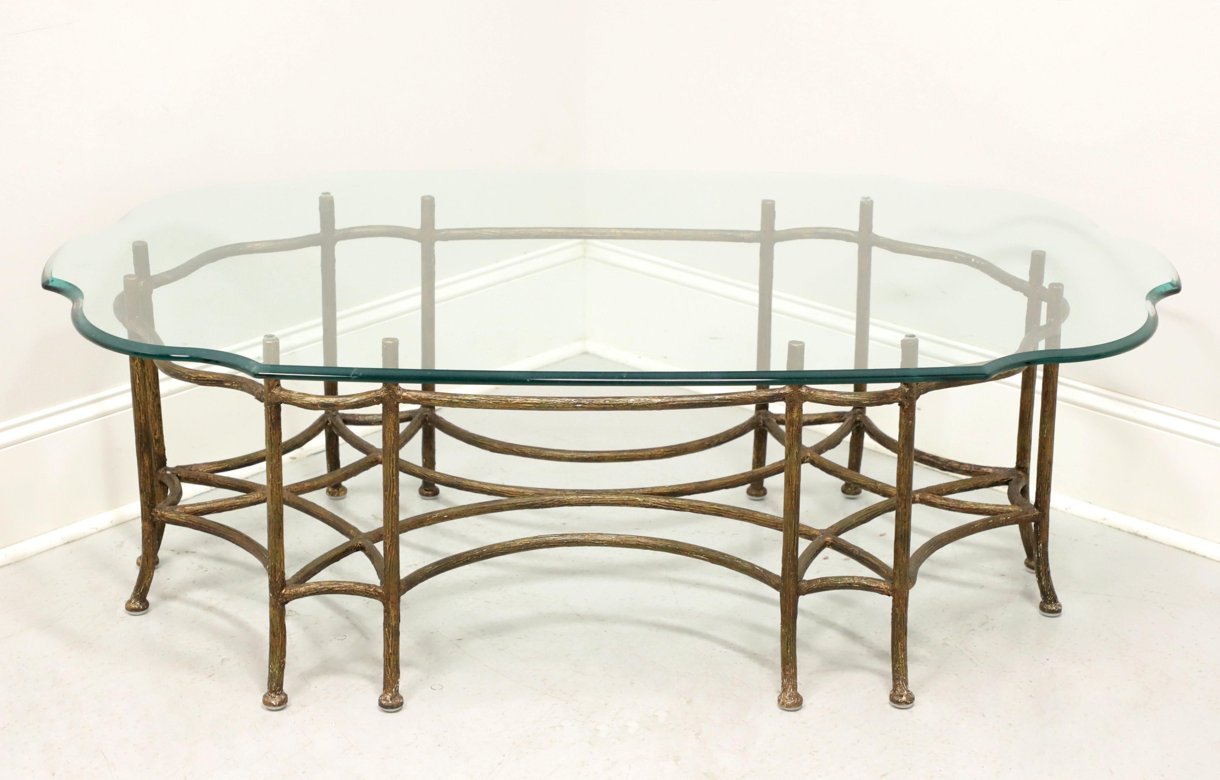 A Transitional style glass top cocktail table, unbranded. Gold tone painted metal base in the form of tree branches creating support for the serpentine shaped ogee edge glass top. Made in the United States, in the late 20th Century.

Measures: