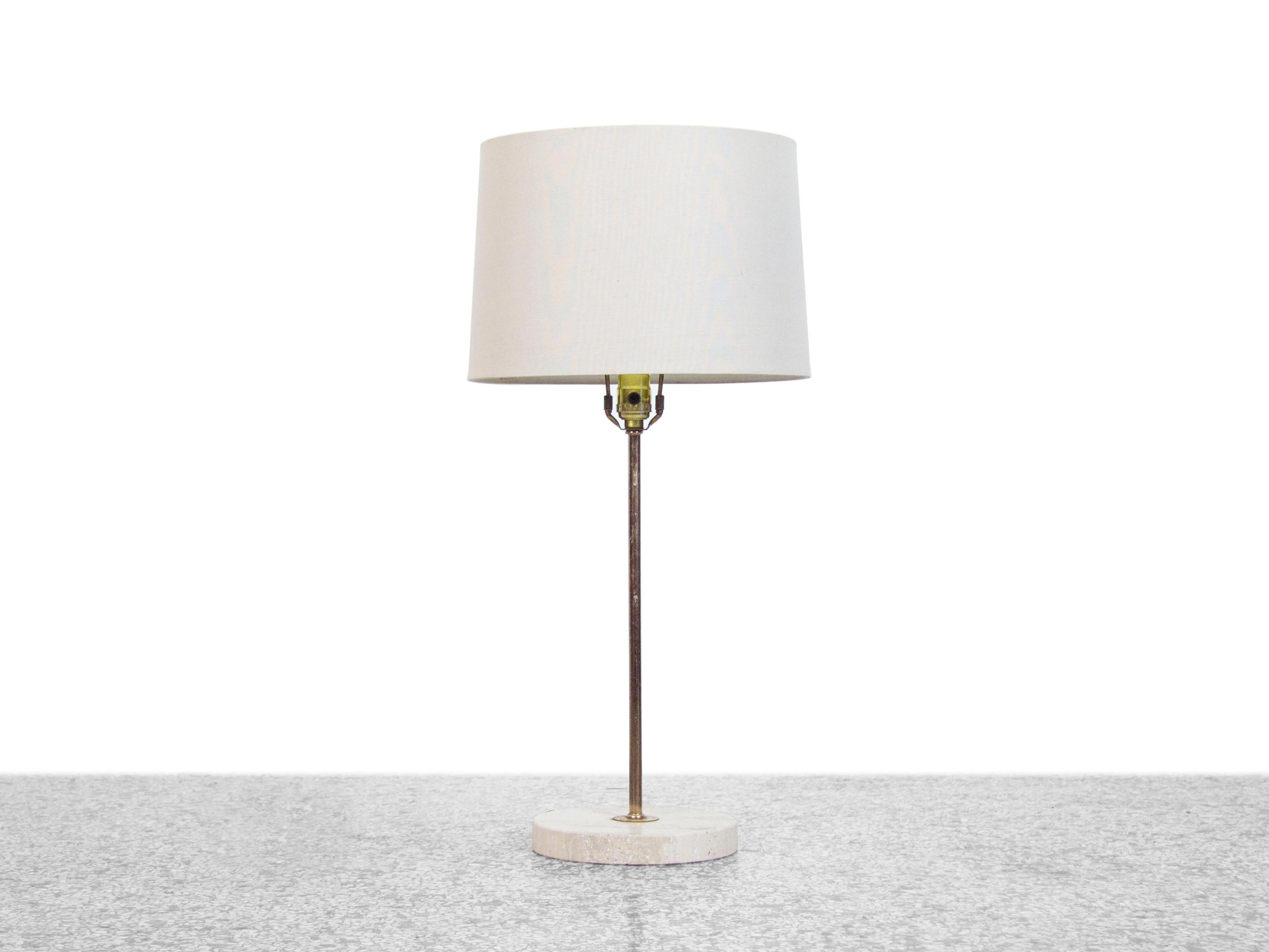 A vintage table lamp with a round travertine base and brass accents. 

*shade not included.