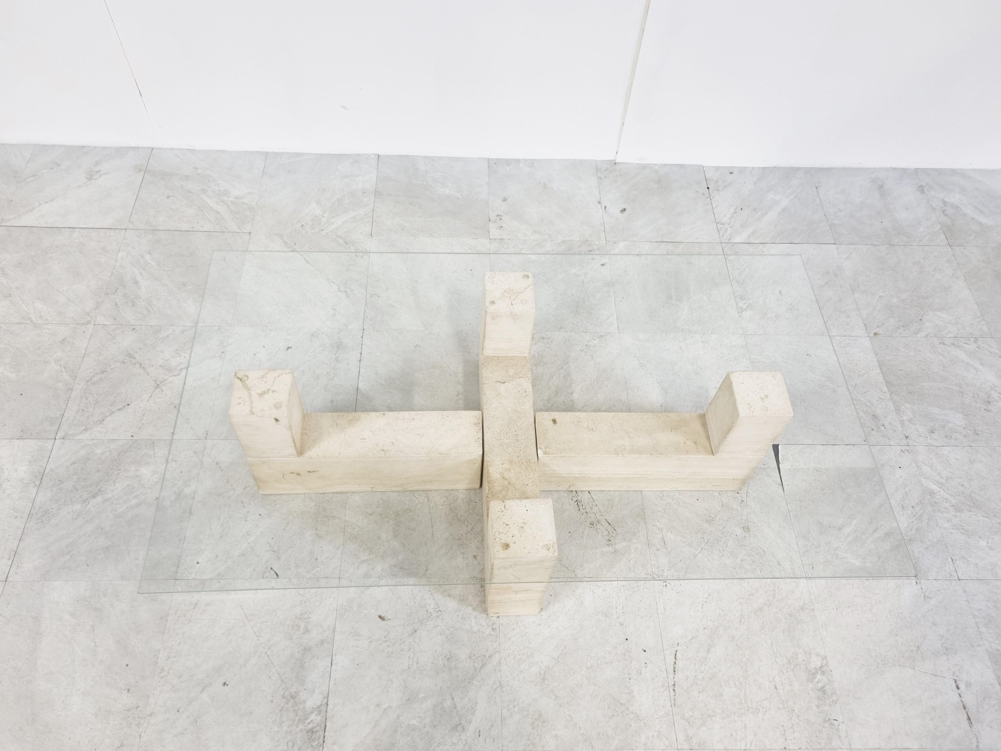 Architectural coffee table with solid travertine bases and a clear glass top.

The modern look/design mixes well with nowadays interiors, especially with the light color of the travertine.

Good condition.

1970s - Italy

The glass top can