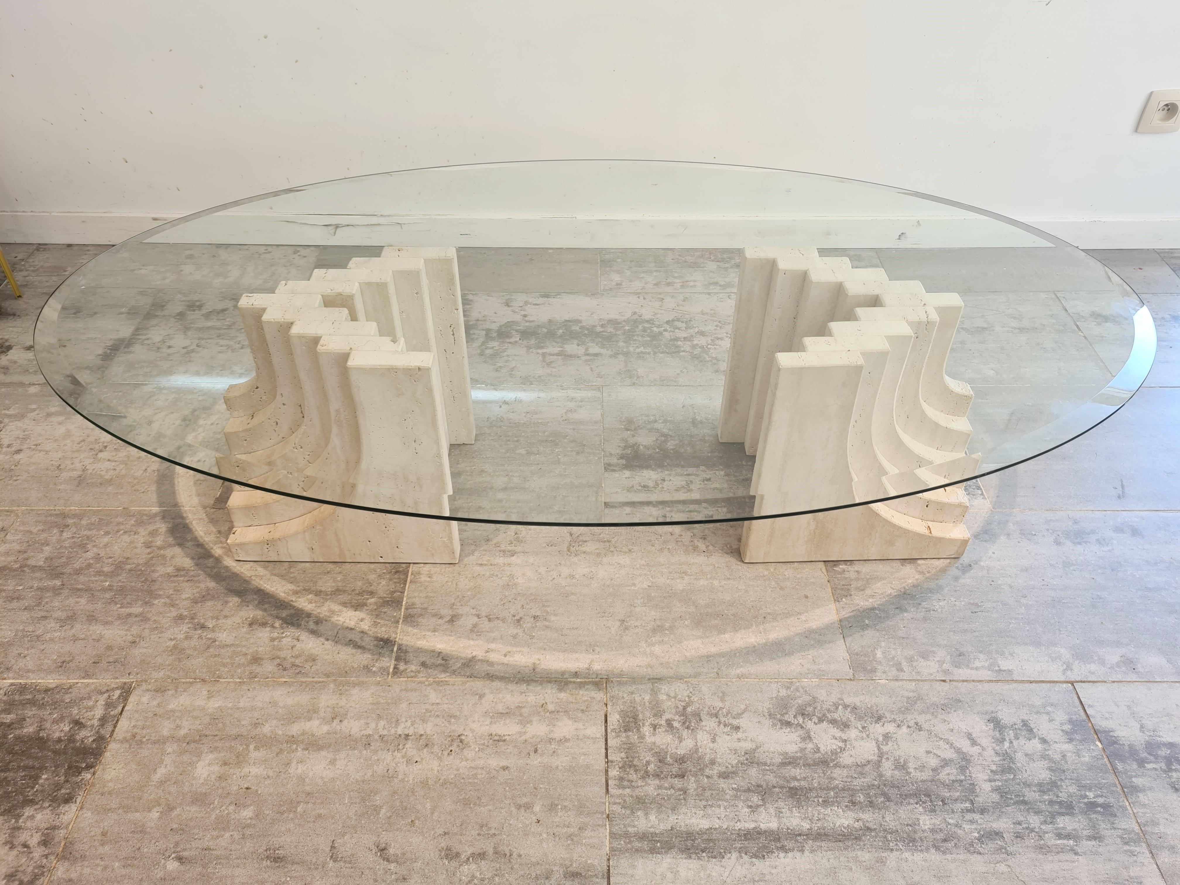 Vintage travertine coffee table with a beveled oval glass top and stepped travertine bases in the style of Carlo Scarpa.

Great look, timeless design.

1970s, Italy

Good condition

Measures: Height 35cm/13.77
