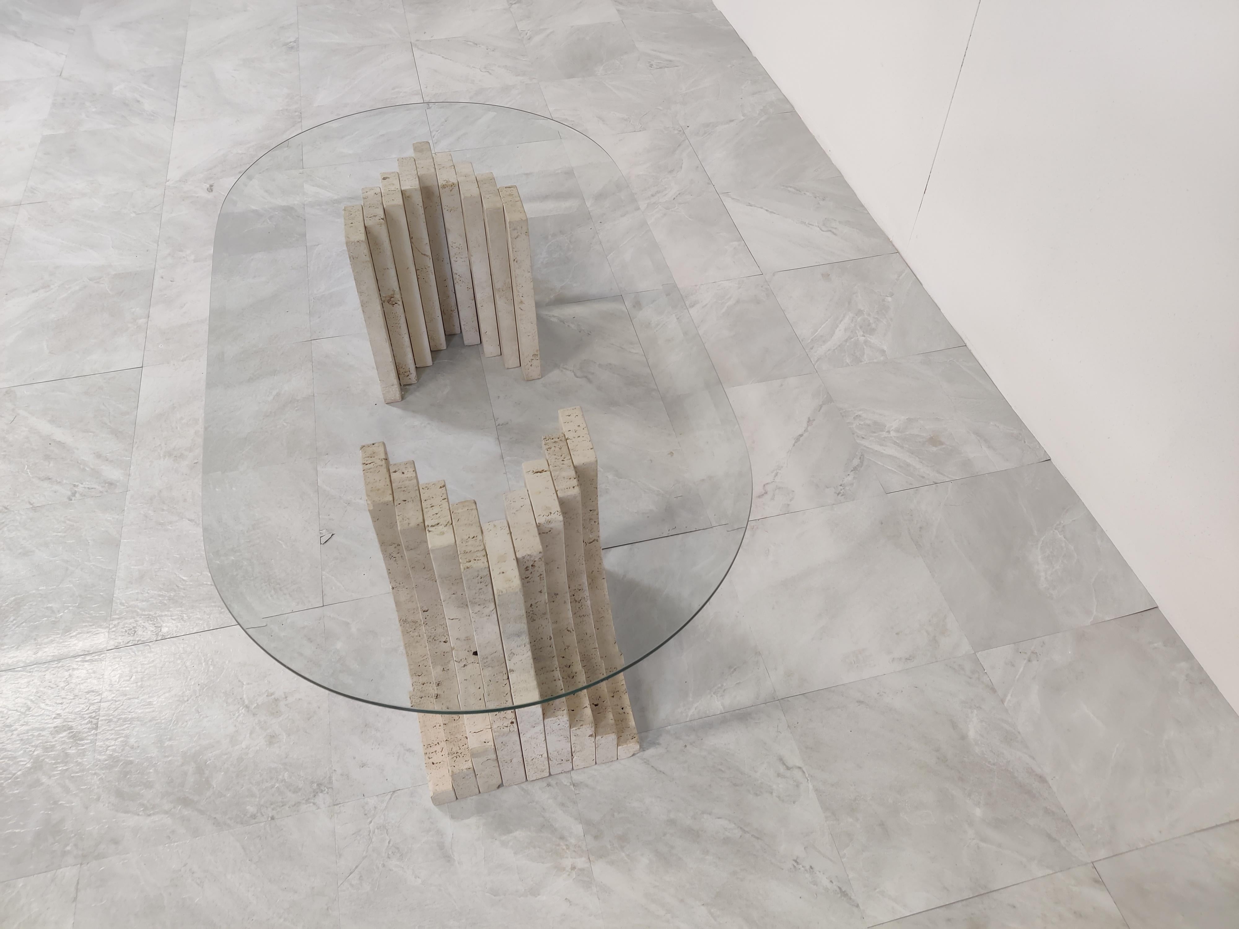 Vintage travertine coffee table with a beveled oval glass top and stepped travertine bases in the style of Carlo Scarpa.

Great look, timeless design.

1970s - Italy

Good condition

Height: 35cm/13.77
