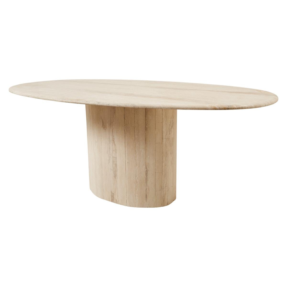 This stunning 1970s French dining table features a travertine oval top and pedestal base. Sleek and modern yet not hard-edged, it has a unique, sculptural presence. This table is a fabulous piece that can comfortably seat six or serve as a statement