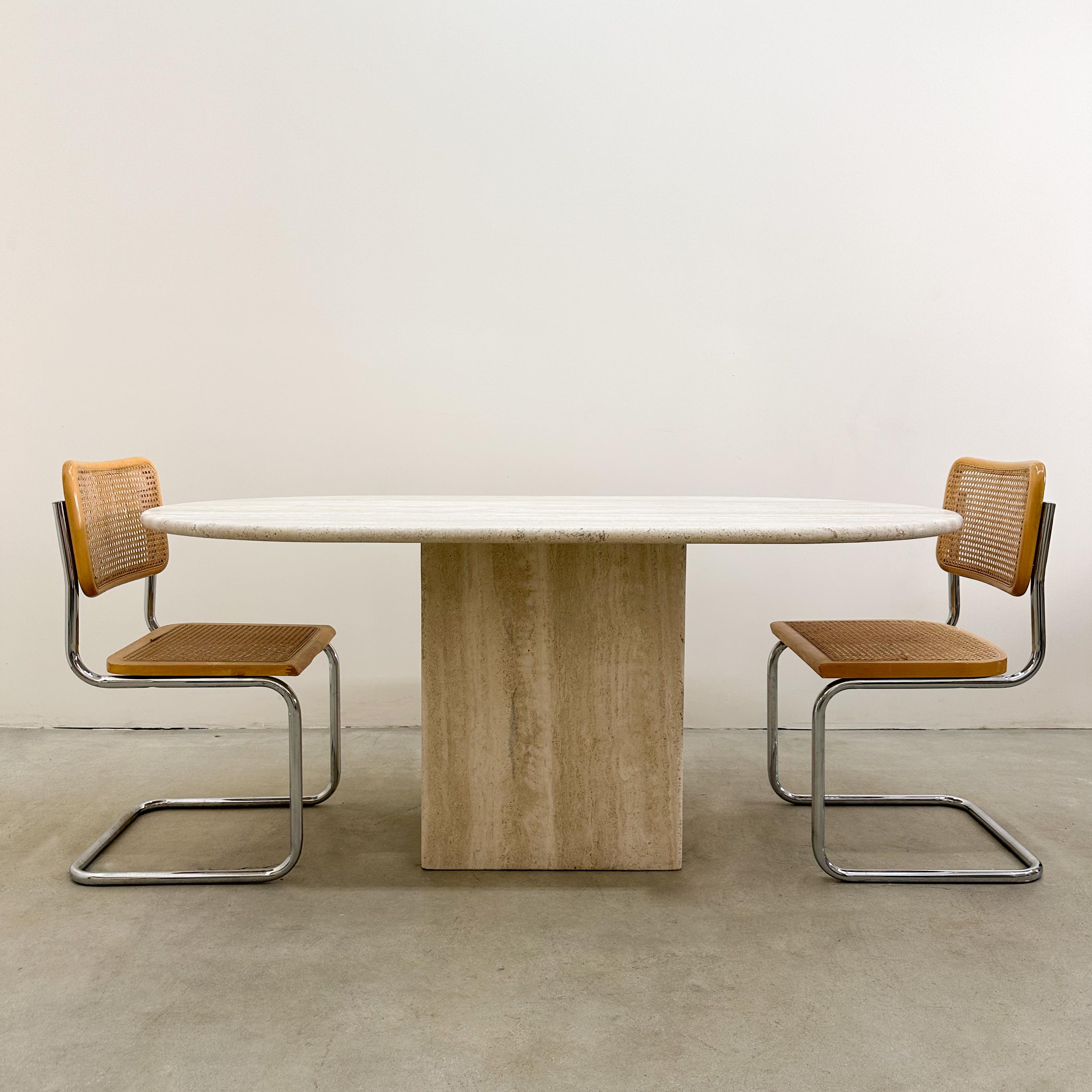 Vintage Oval Travertine Dining Table. 

Made out of solid travertine stone. It's in two parts. The tabletop rests on the base. 
The table is honed with no shine. Made very well. Very heavy. Seats 4 to 6, depending on the the chairs. You can also use