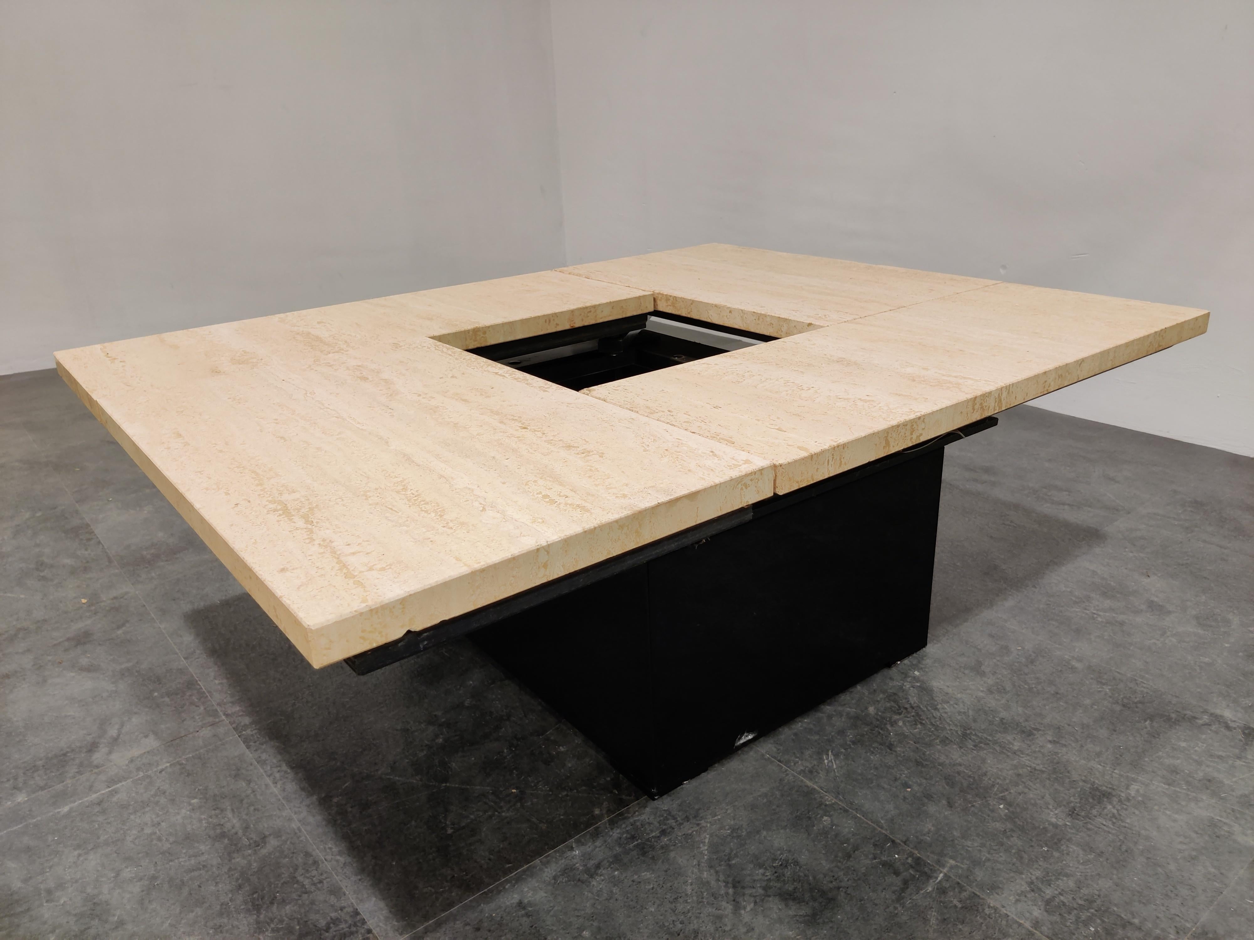 Vintage travertine hidden bar coffee table.

With the top closed it looks like a regular coffee table, but open it up and it reveals a mirrored storage space for glasses and bottles.

A great coffee table to add some 1970s glamour period
