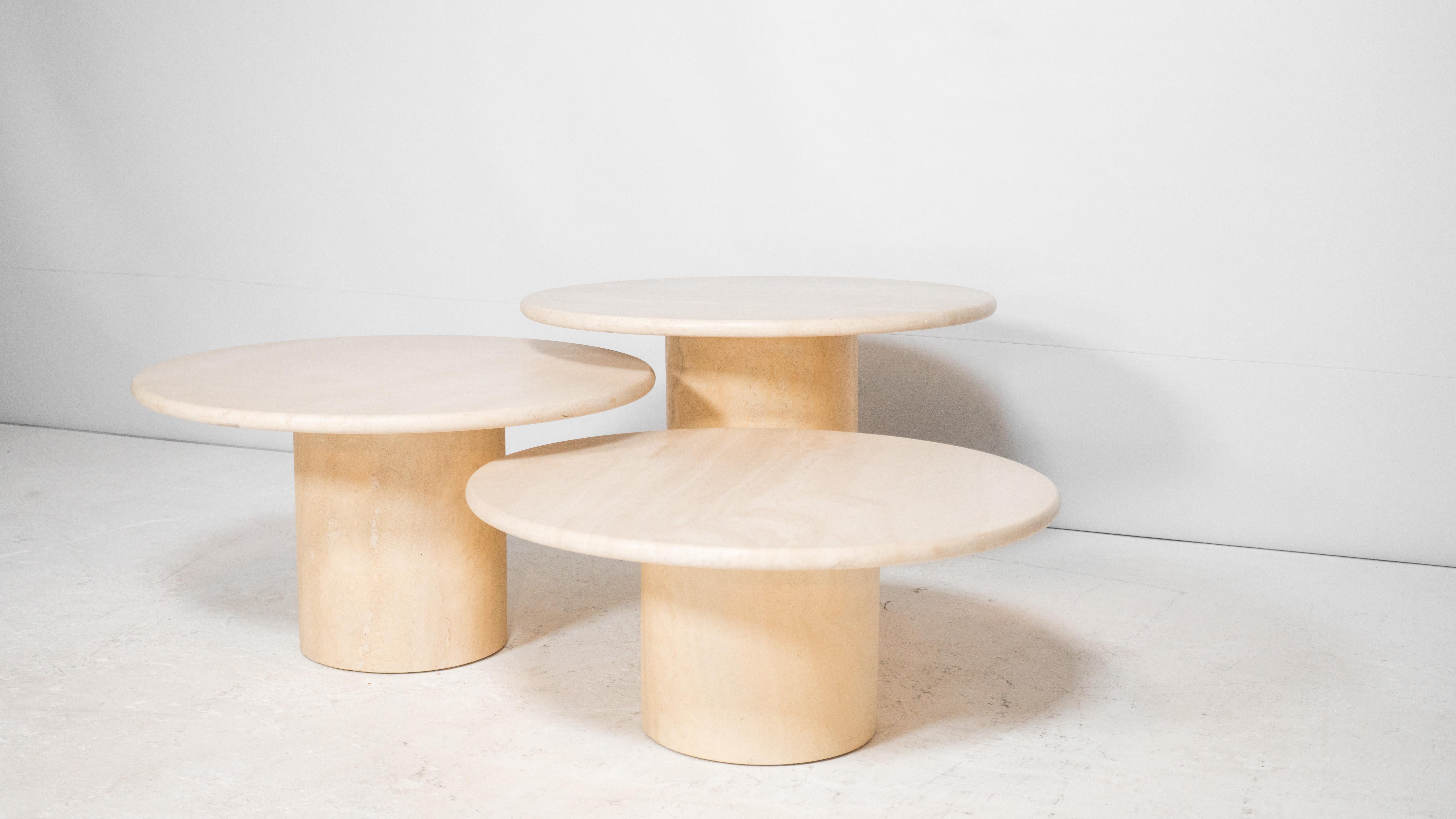 Vintage Italian Travertine round nesting or coffee tables, circa 1970s. Comprised of three tables that vary in height, allowing the set to have overlapping tops, creating one large coffee table form. Can also be used as individual side tables.