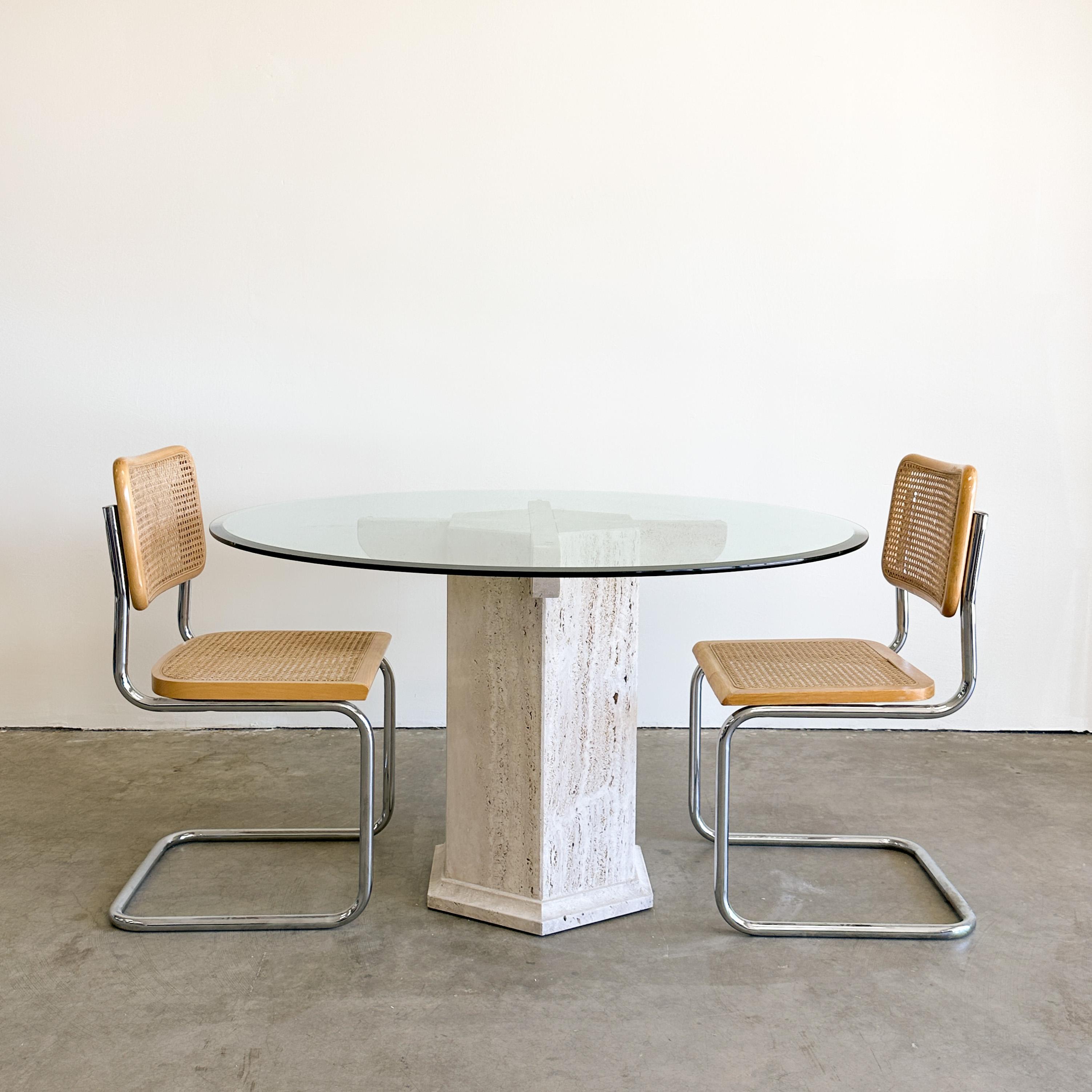 Vintage 80s, Travertine & Glass Dining Table. 

The base is made out of solid travertine stone. It's in two parts. The glass rests on the base. The travertine holes have not been filled on the base.  Made very well. Very heavy.
 
Color: