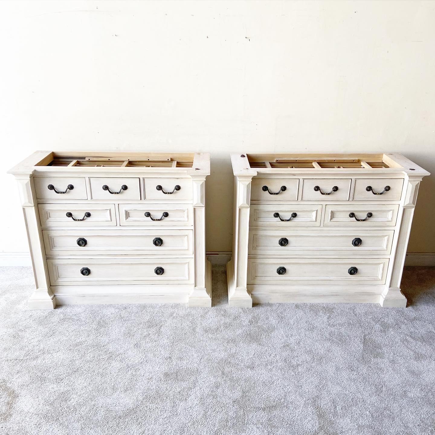 Exceptional pair or commodes/small dressers by Henredon. Each feature 7 spacious drawers with Italian travertine tops.
 