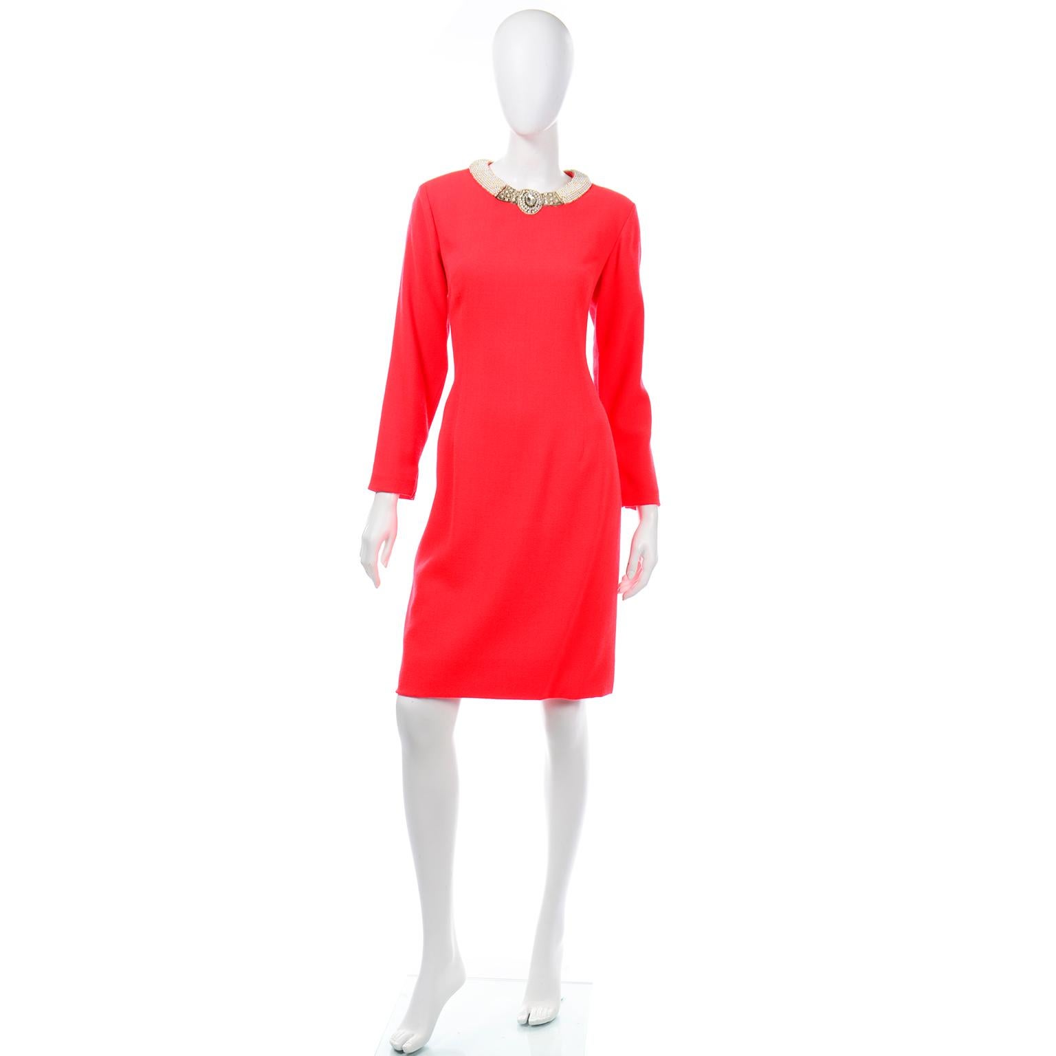 This is a really fun Travilla bright red wool crepe dress made for Saks Fifth Avenue. We especially love the jeweled collar with gold beads, faux pearls, crystal beads, rhinestones, and metallic thread embroidery. The long sleeve dress has metal