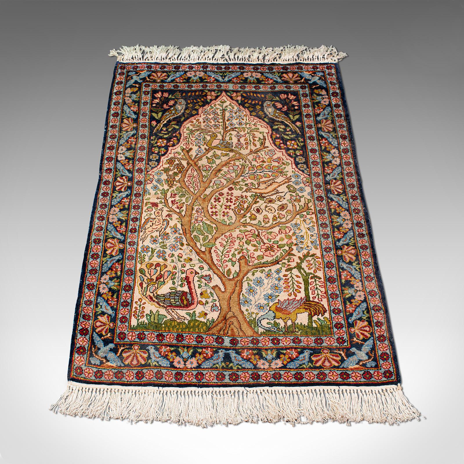 This is a vintage tree of life rug. A Caucasian, woven small carpet or prayer mat, dating to the late Art Deco period, circa 1940.

Of useful doorway size at 55cm x 95cm (21.75