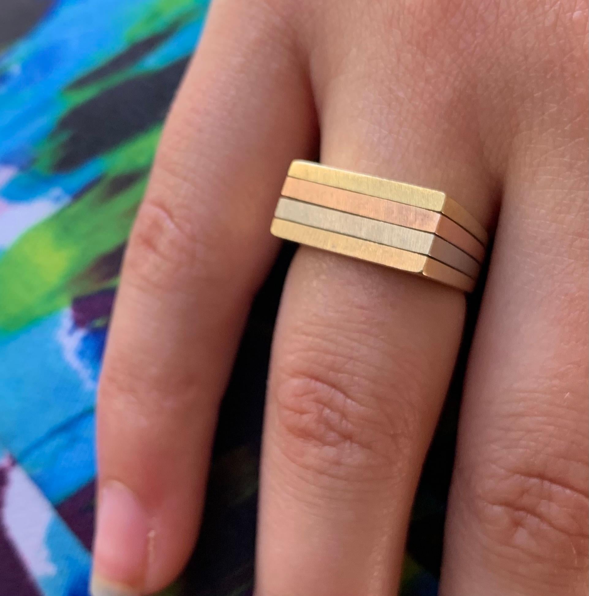 Streamlined textured finish front panel, finely polished on the sides and back, this unusual ring is composed of four tiers of yellow, white, rose and yellow 14K gold which are fused together at the back and subtly widen towards the front for a