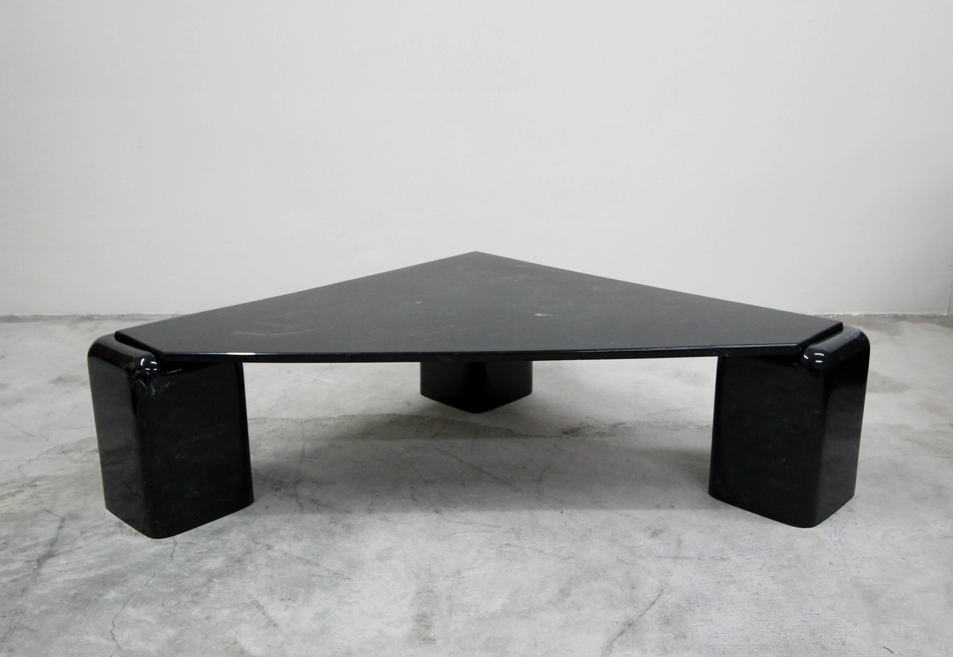 Super unique, three-leg, triangular shaped, black Italian marble coffee table.

Beautiful black and white marble top and legs. Table top sets perfectly into the cutouts of the rounded legs.

True designer piece.
