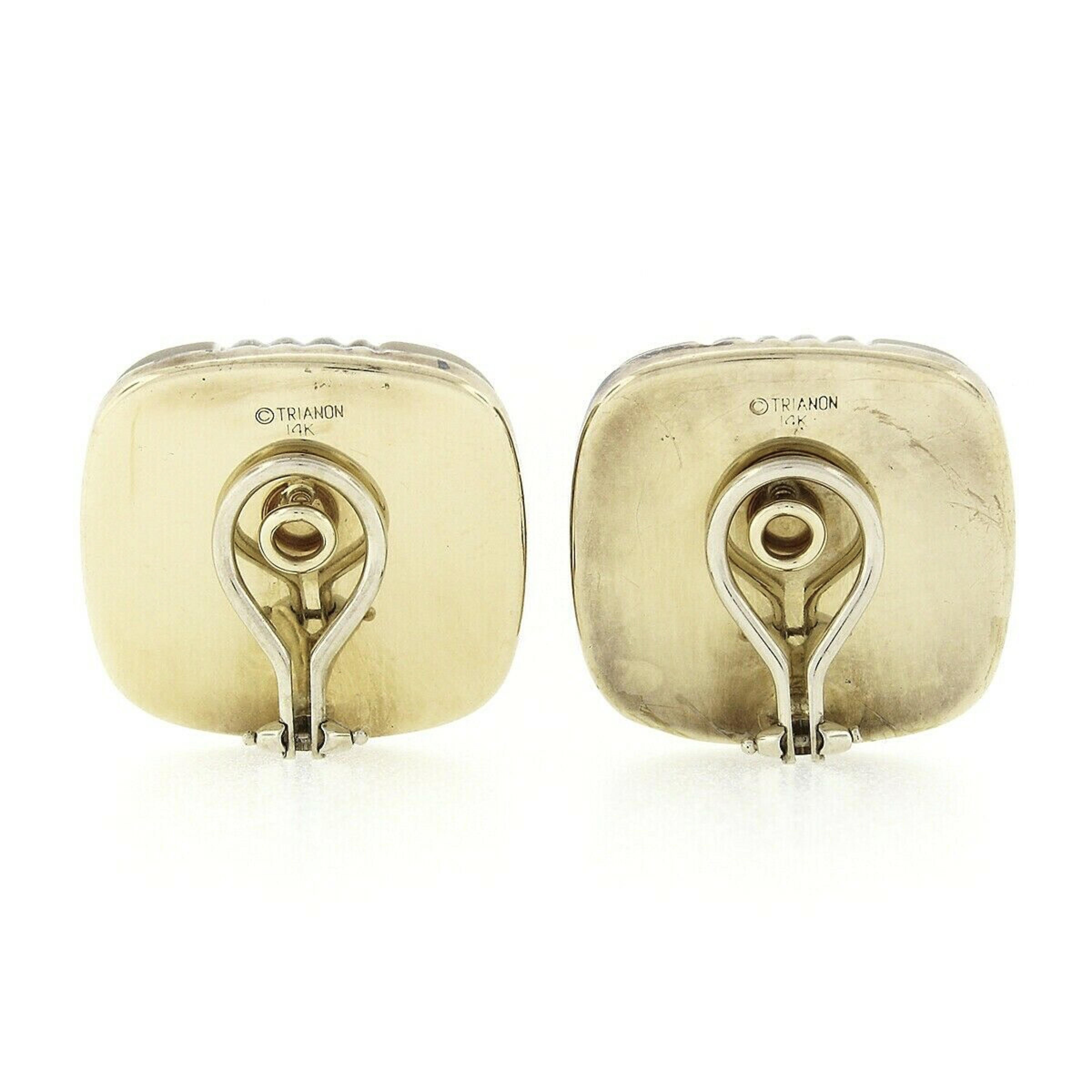 Here we have a gorgeous pair of vintage designer earrings that were crafted from solid 14k yellow and white gold by Trianon. The earrings each feature a large, domed, square cushion cut piece of natural quartz that measures approximately 23.5mm