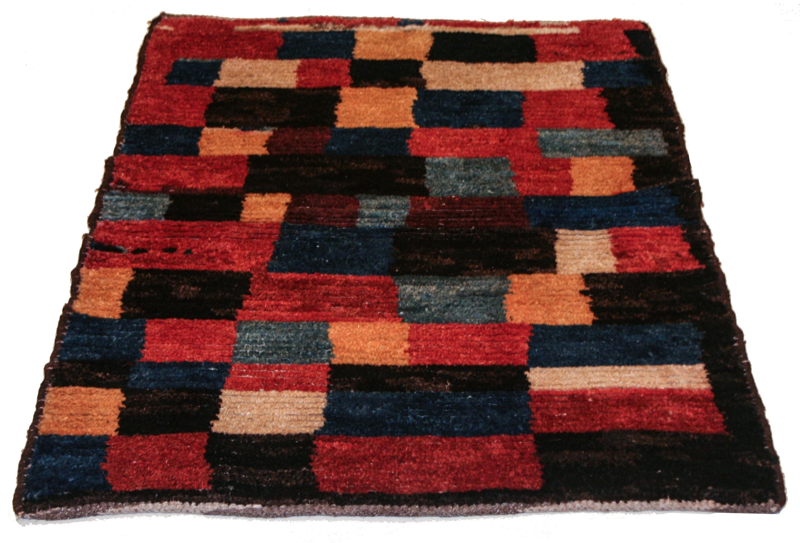 A small tribal rug distinguished by an abstract rendition of the checkerboard pattern. The wonky, naive-like character of the design is typical of the most genuine tribal rugs, which are often executed by younger, more inexperienced weavers. A