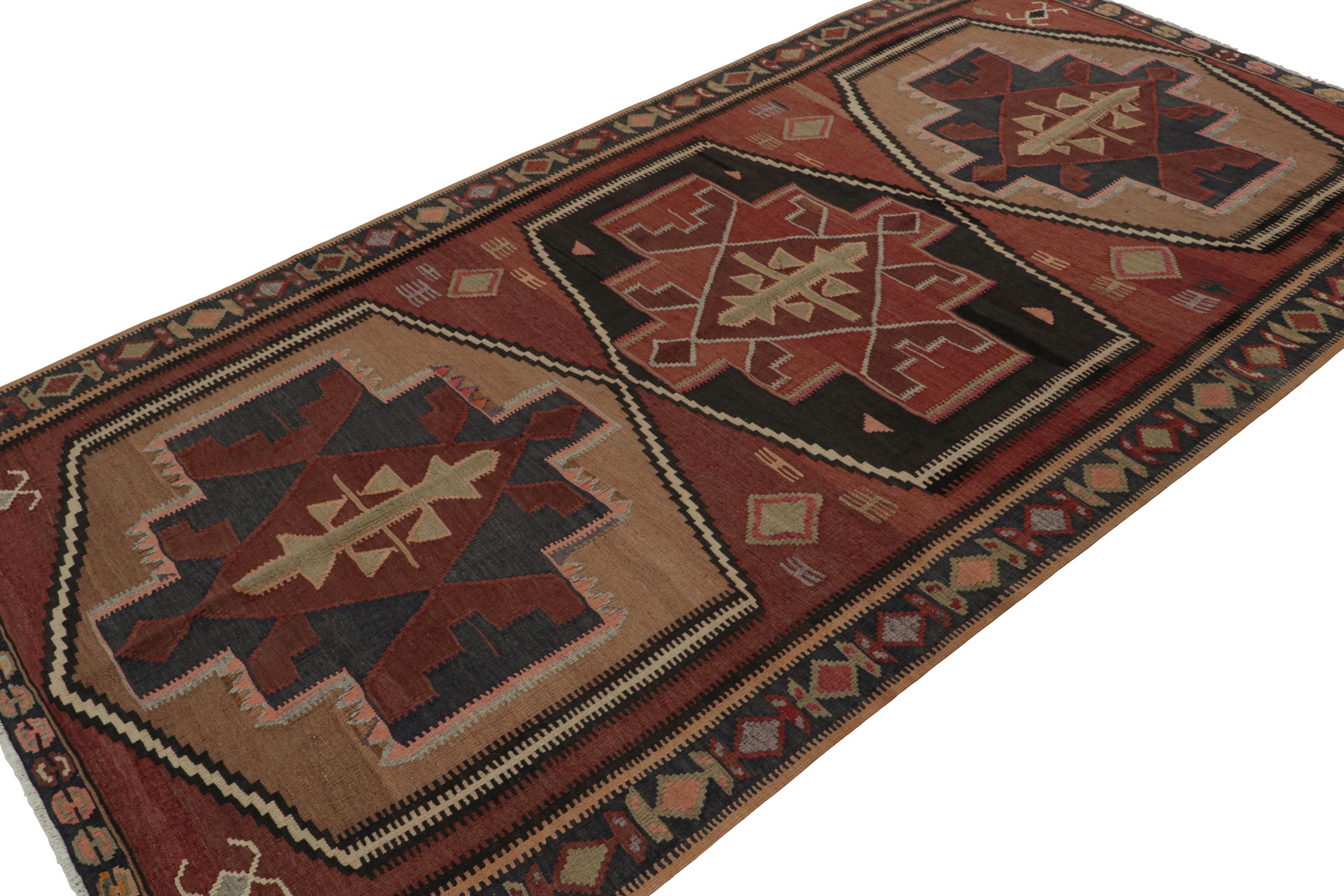 Handwoven in wool, circa 1950-1960, this 5x9 vintage tribal Afghan kilim rug features large-scale medallions with geometric patterns in playful accents of red, blue, and subtle tones of beige/brown and green. 

On the Design: 

Connoisseurs will