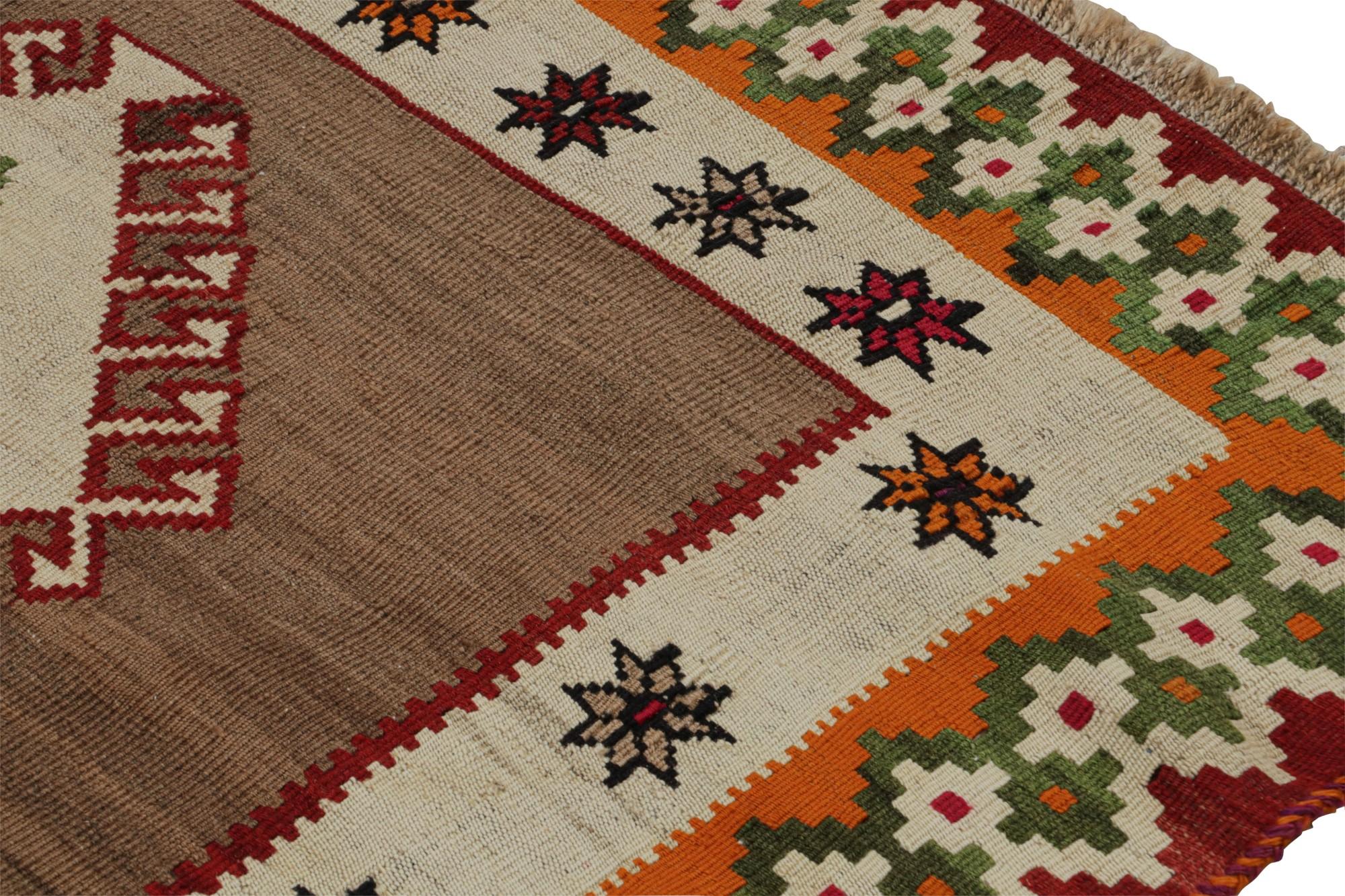 Handwoven in wool, circa 1950-1960, this 4x8 vintage tribal Afghan kilim rug features vibrant medallions and geometric patterns in beige/brown, green, blue and red. 

On the Design:

A special piece in the Rug & Kilim collection, this rug showcases