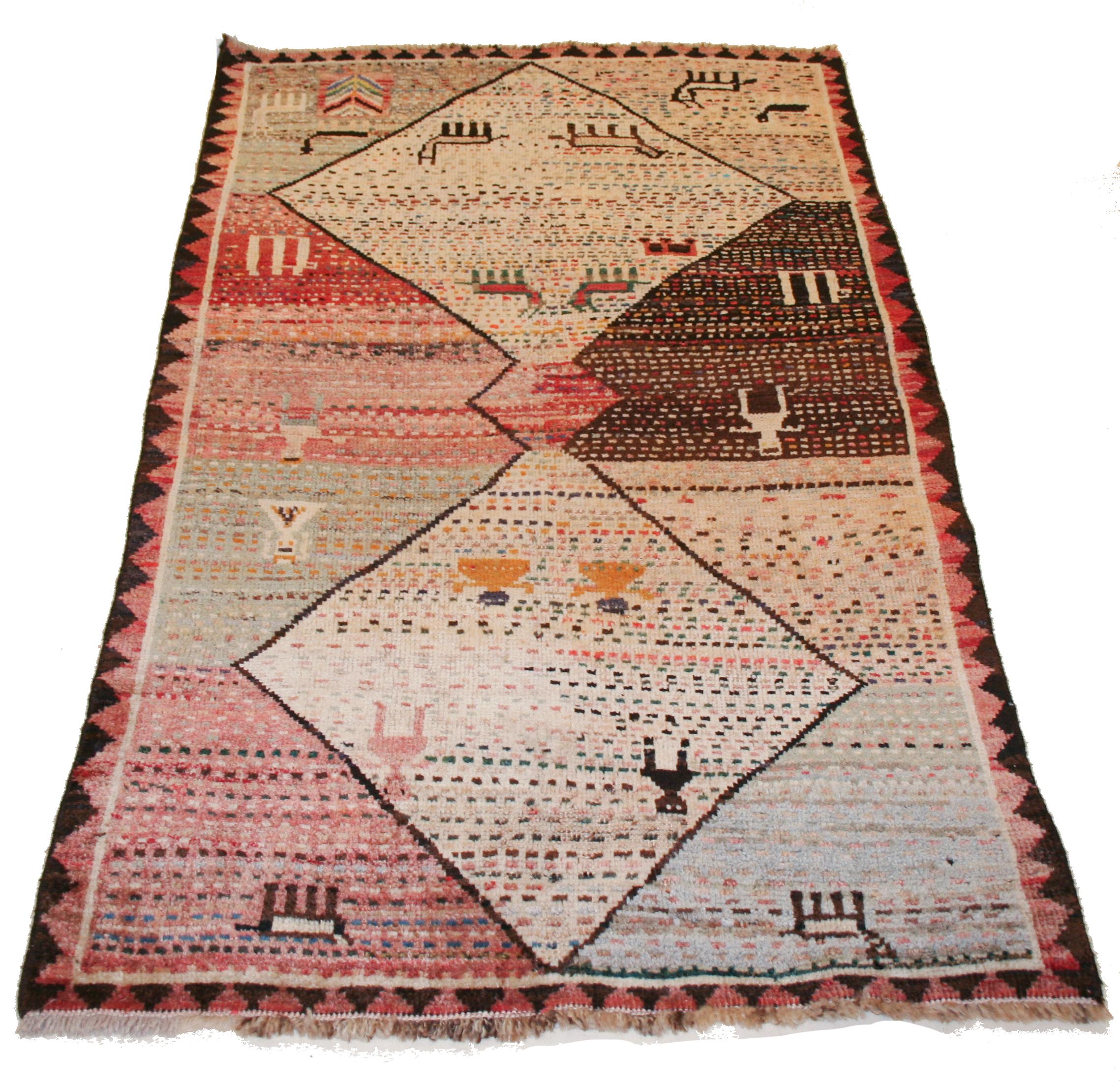 The naive character of this charming, diminutive tribal rug is exactly what distinguishes it from the plethora of commercial oriental rugs. The diamond design field is completely filled with small dots, alternated to other geometric devices typical
