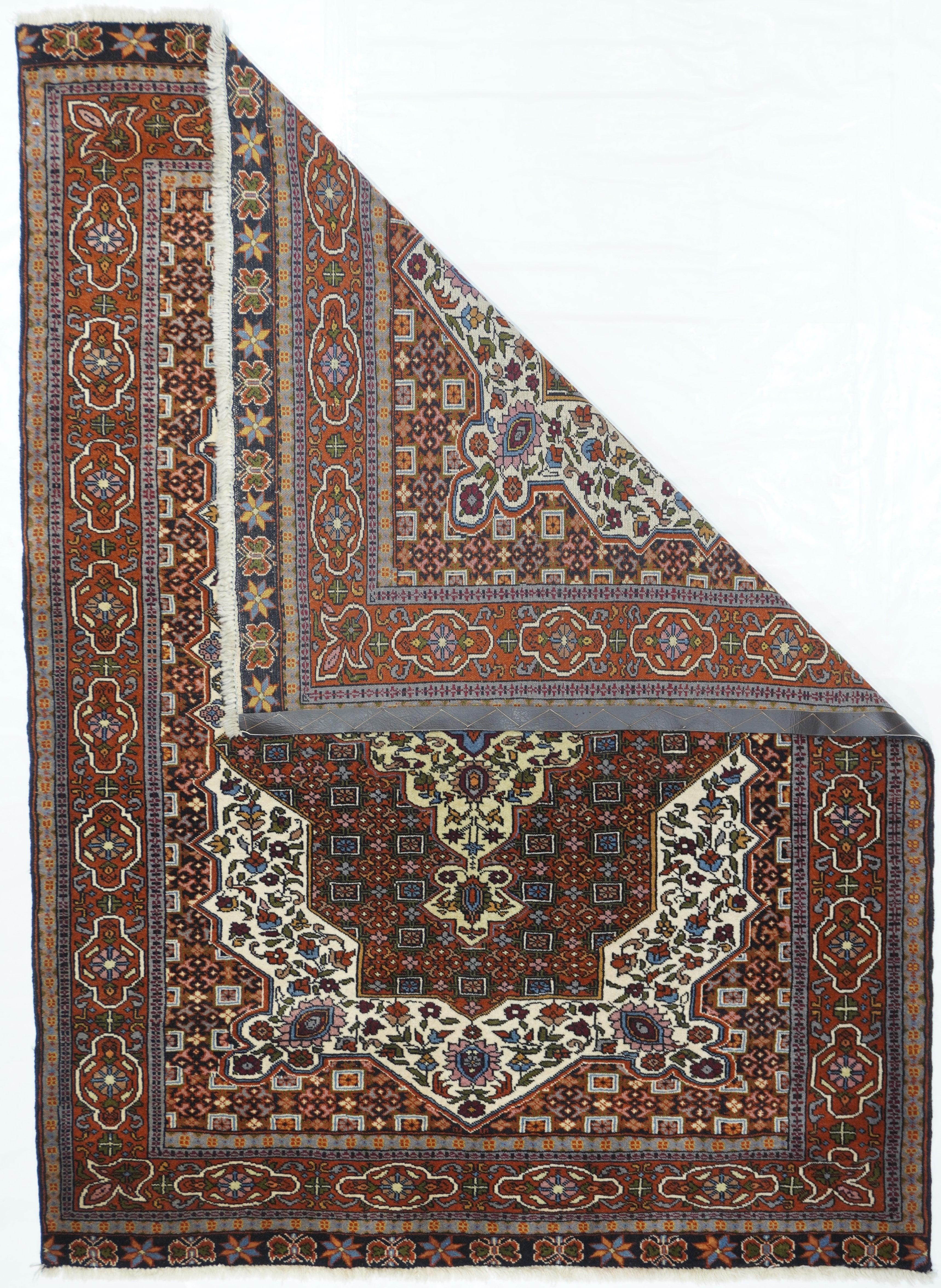 Vintage tribal Ghashghai rug measures 4'5'' x 6'1''. Although this finely knotted scatter is a southwest Persian nomadic creation, it has many of the features of a more refined city rug. A light blue Sub-medallion focuses the surrounding light straw