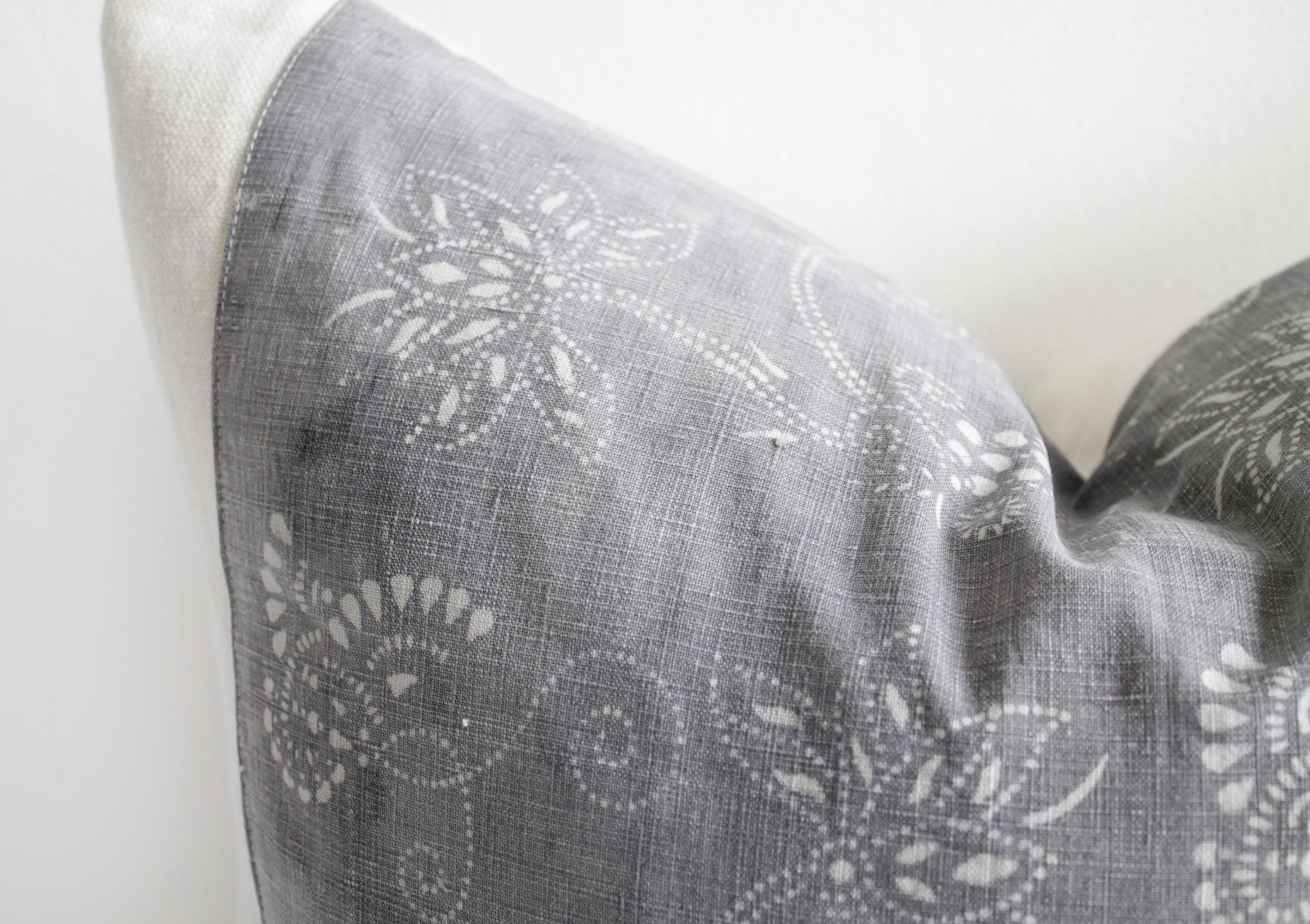This beautiful pillow features a vintage textile face in a faded gray and soft white pattern, blocked with a light sand European linen, and backed with the same linen. Our pillows are constructed with vintage one of a kind textiles from around the