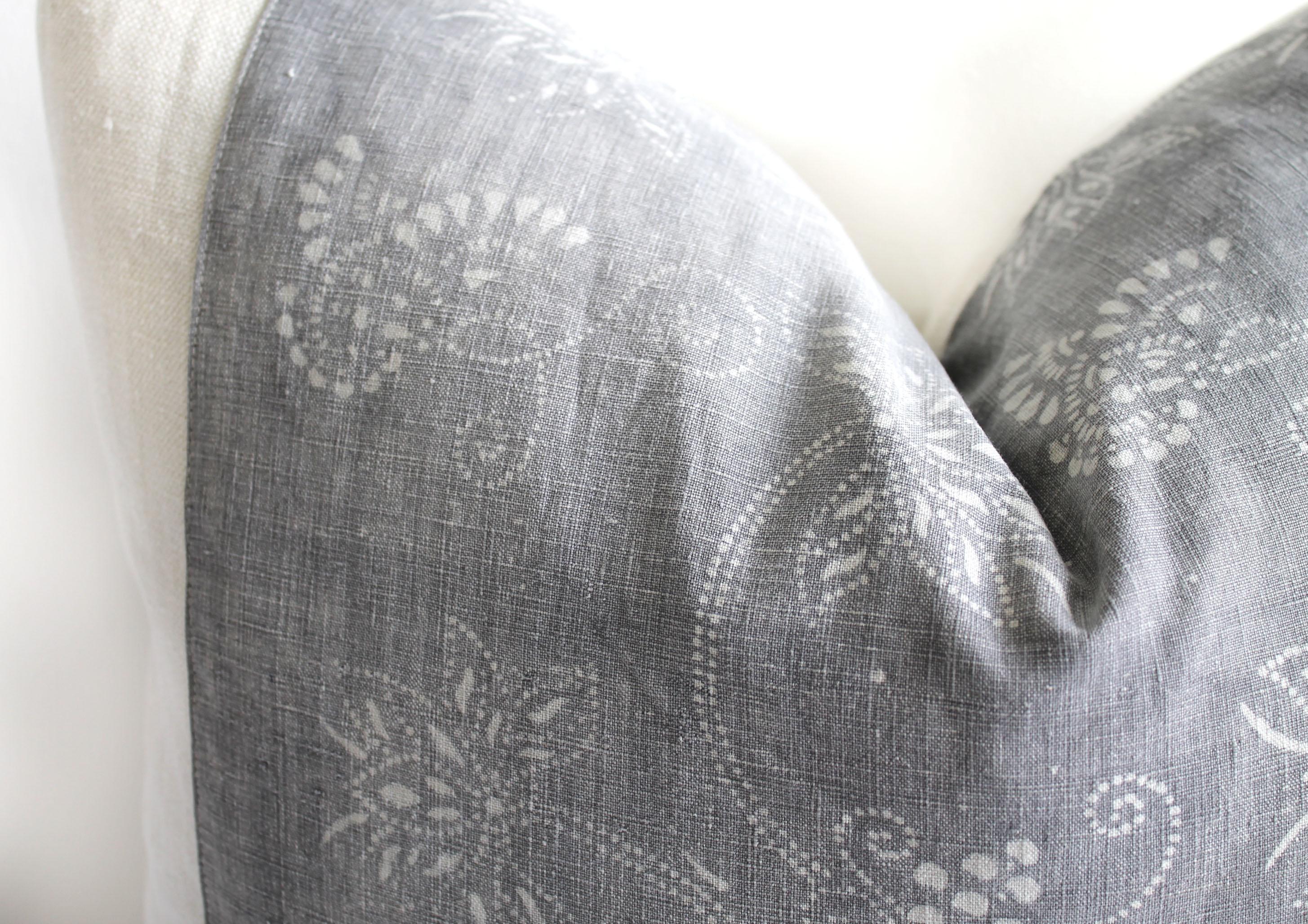 This beautiful pillow features a vintage textile face in a faded gray and soft white pattern, blocked with a light sand European linen, and backed with the same linen.
Our pillows are constructed with vintage one of a kind textiles from around the