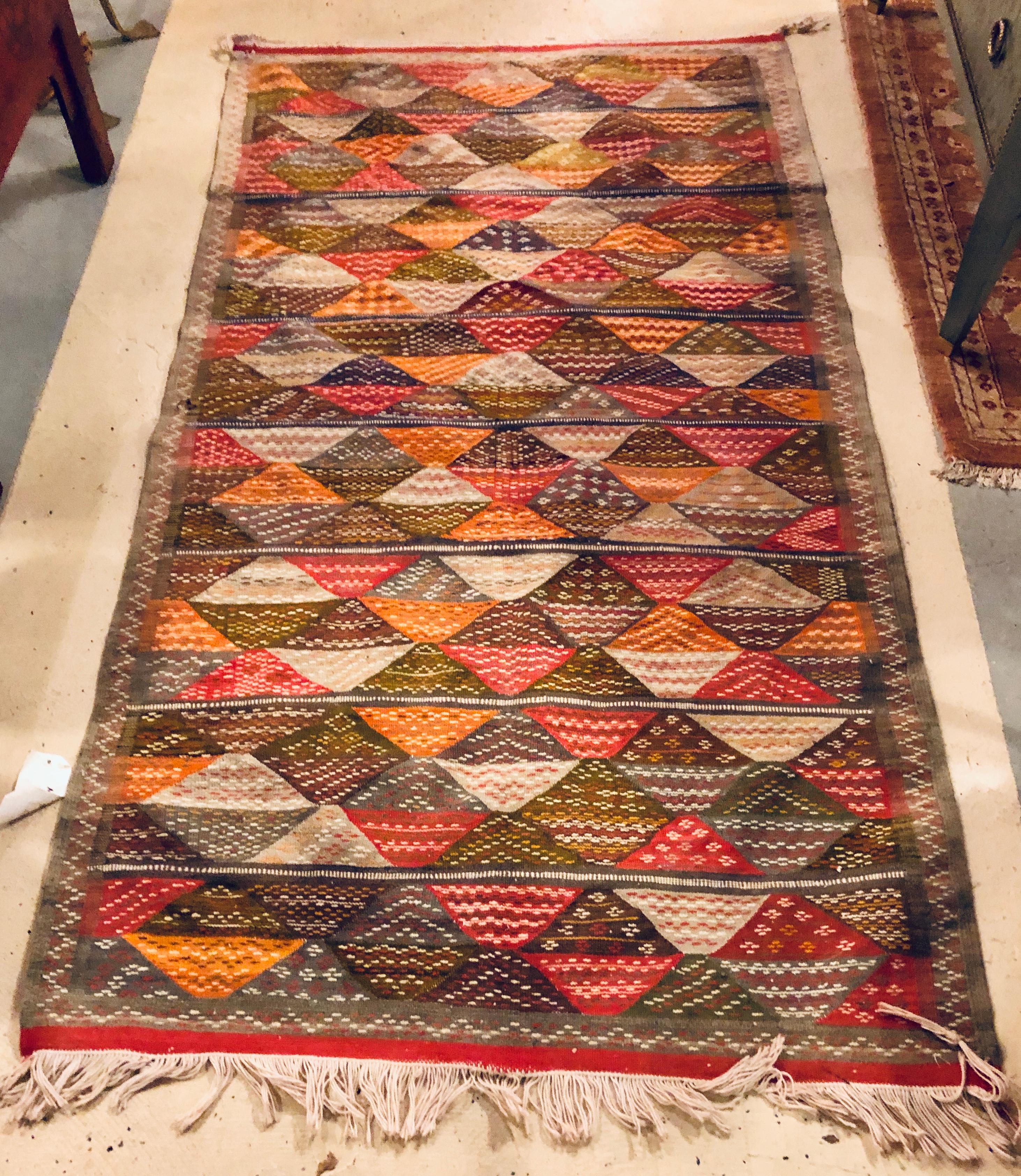 Vintage Tribal handwoven wool and organic dye rug or carpet in triangle patterns
 This stunning handwoven rug from the Atlas mountains of Morocco is and sophisticated addition to a diverse range of living spaces including living rooms, dining